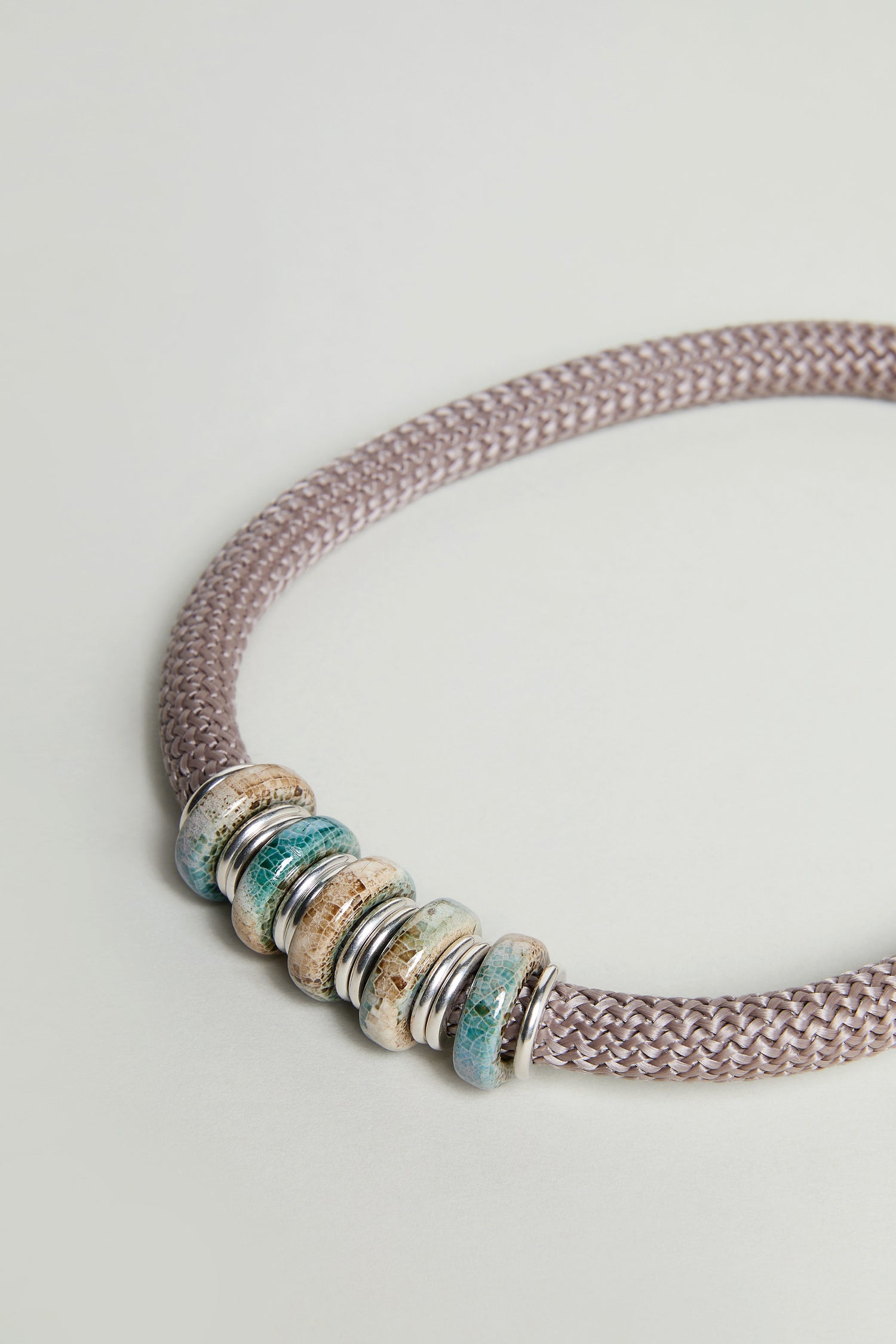 A close-up of the Mosaic Cylinder Bead Short Cord Necklace, highlighting its bold design and detailed craftsmanship.