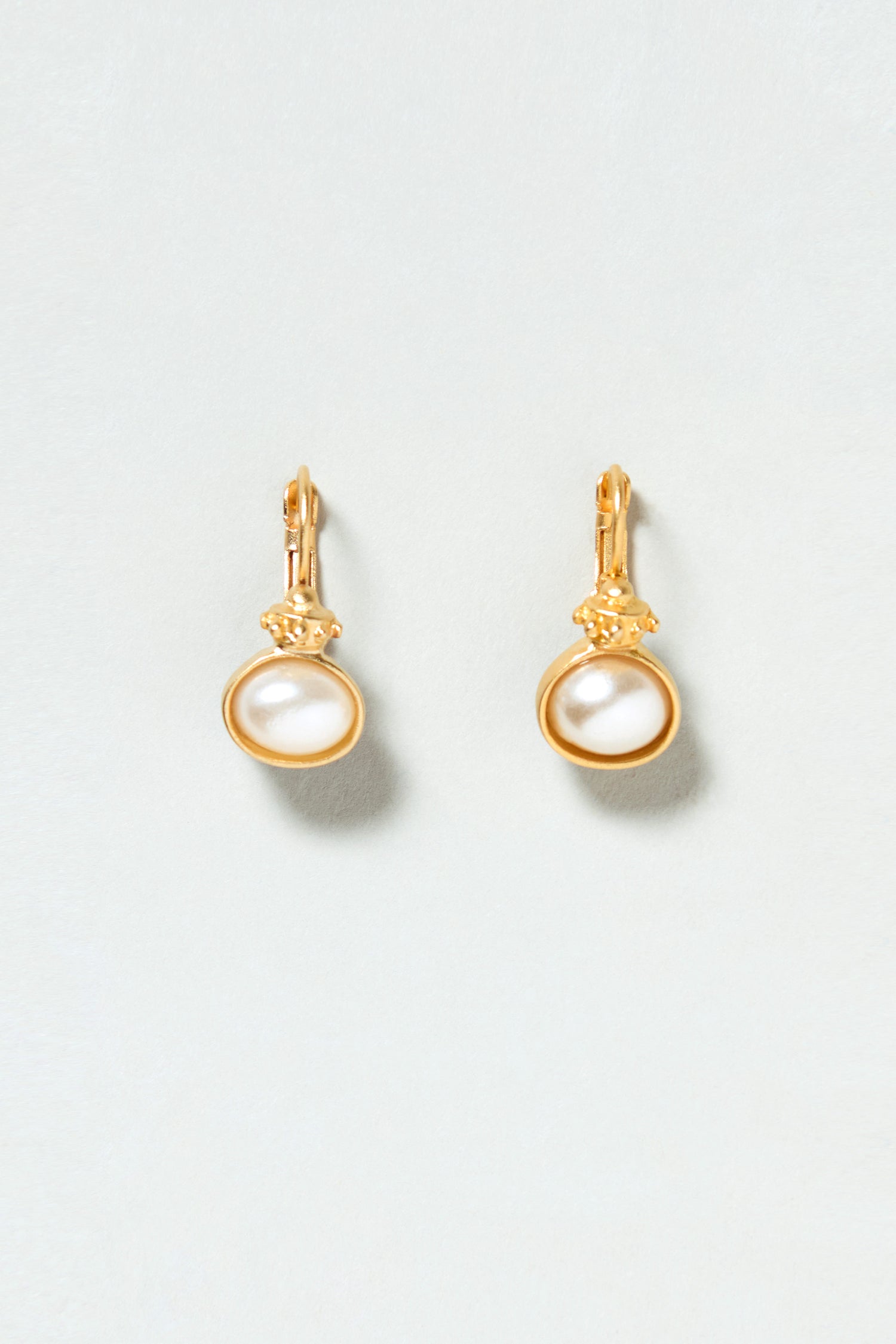 Gold Plated Pearl Drop Earrings with round white pearls are shown against a light grey background.