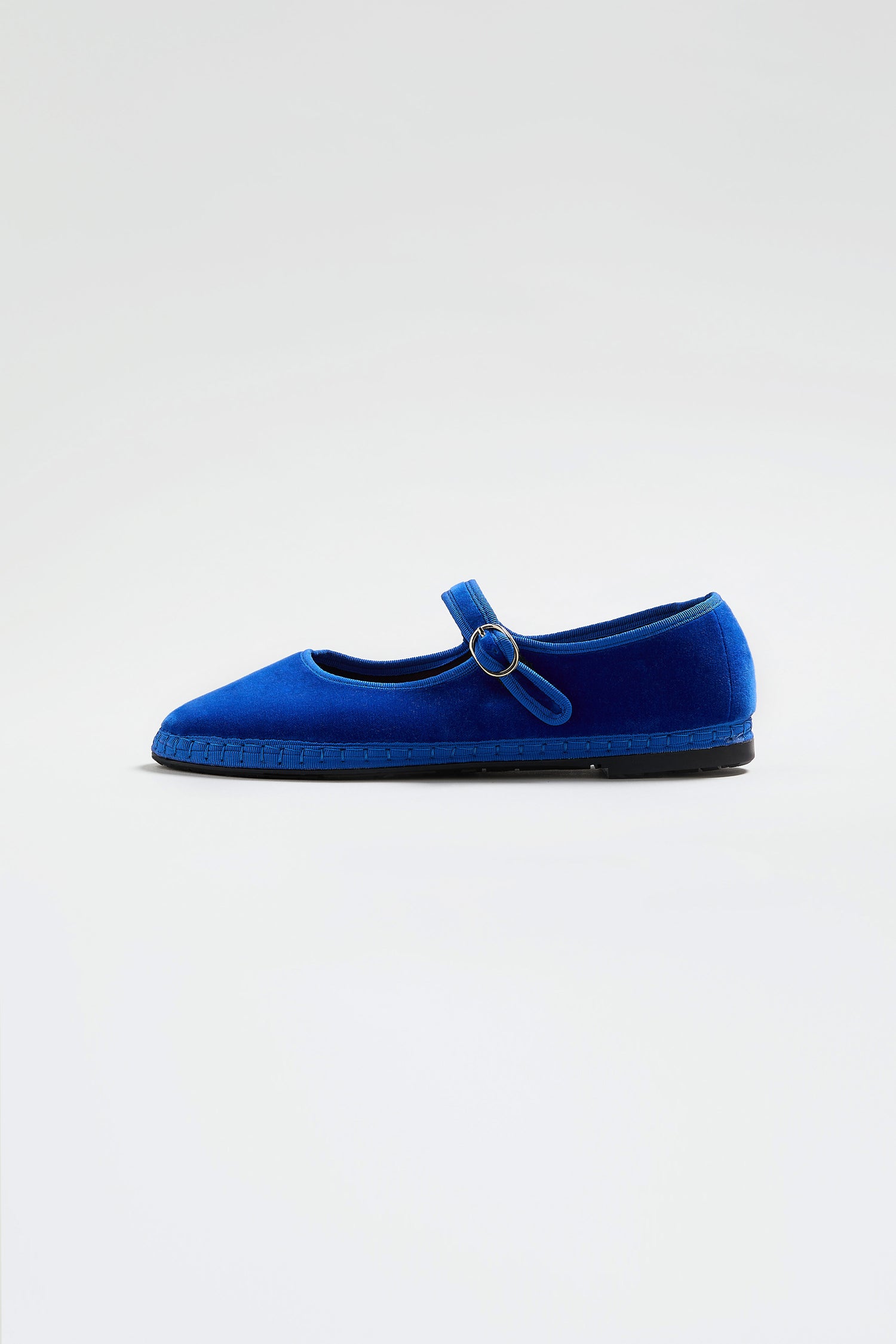 A single blue Mary Jane Velvet Shoe for women, featuring a thin strap and buckle, displayed on a plain light background—a timeless choice in sustainable fashion.