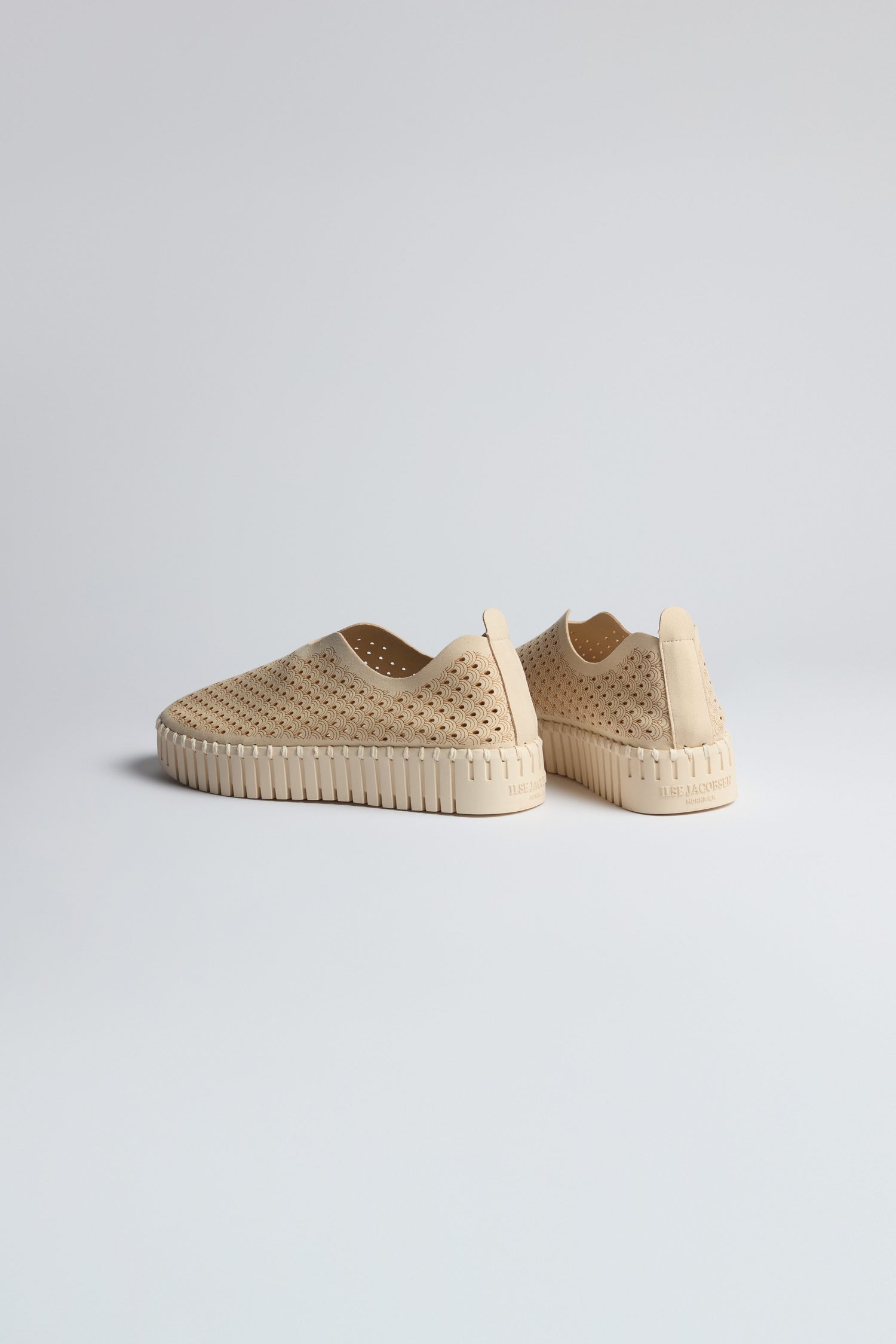 Two beige Tulip Slip On Shoes by Ilse Jacobsen, featuring perforated uppers and textured platform soles, are set on a plain light background, facing away from each other.