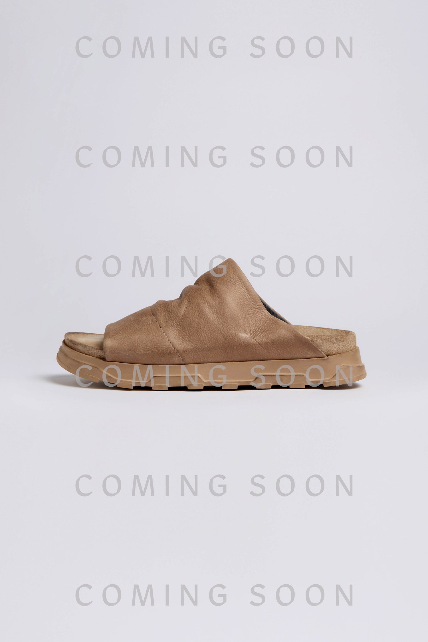The Crushed Leather Sliders are shown against a light background with “COMING SOON” repeatedly overlaid in gray.