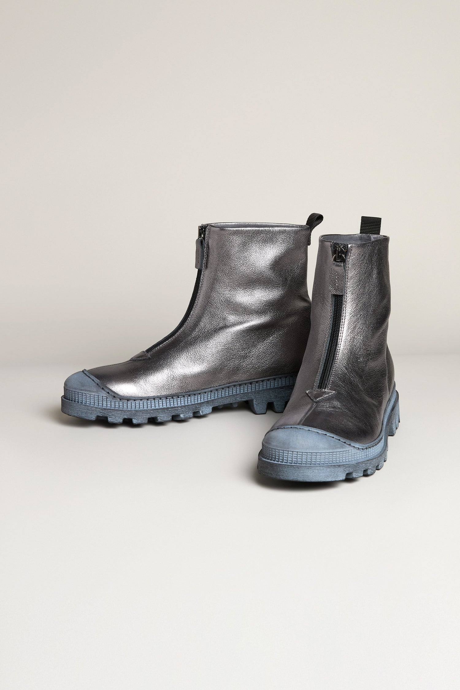 Gunmetal Zip Front Leather Boots with metallic leather finish, front zippers, and bold blue rubber soles shown on a neutral background.