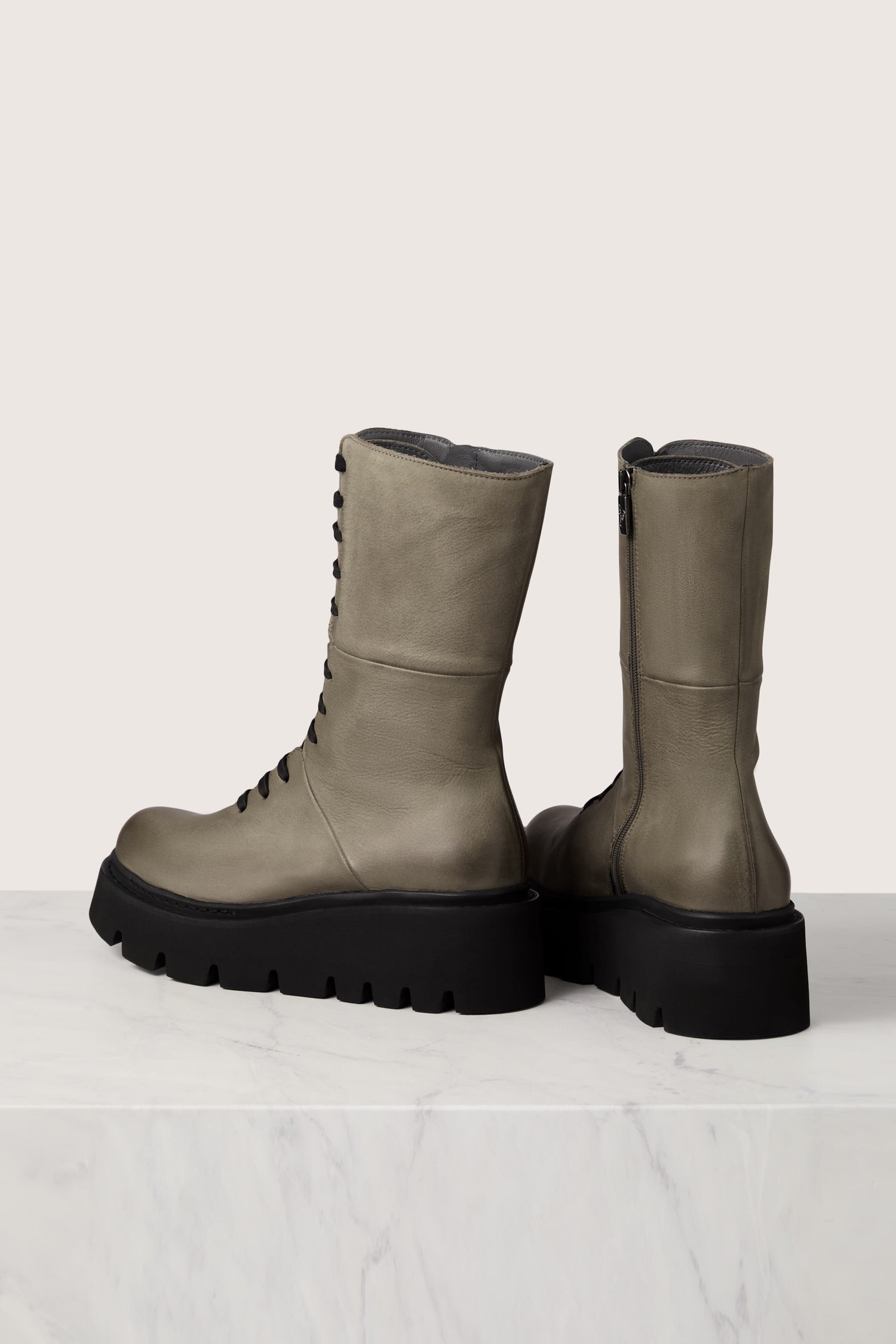 A pair of grey leather Platform Lace Up Leather Boots with black soles, showcasing exquisite Italian craftsmanship.