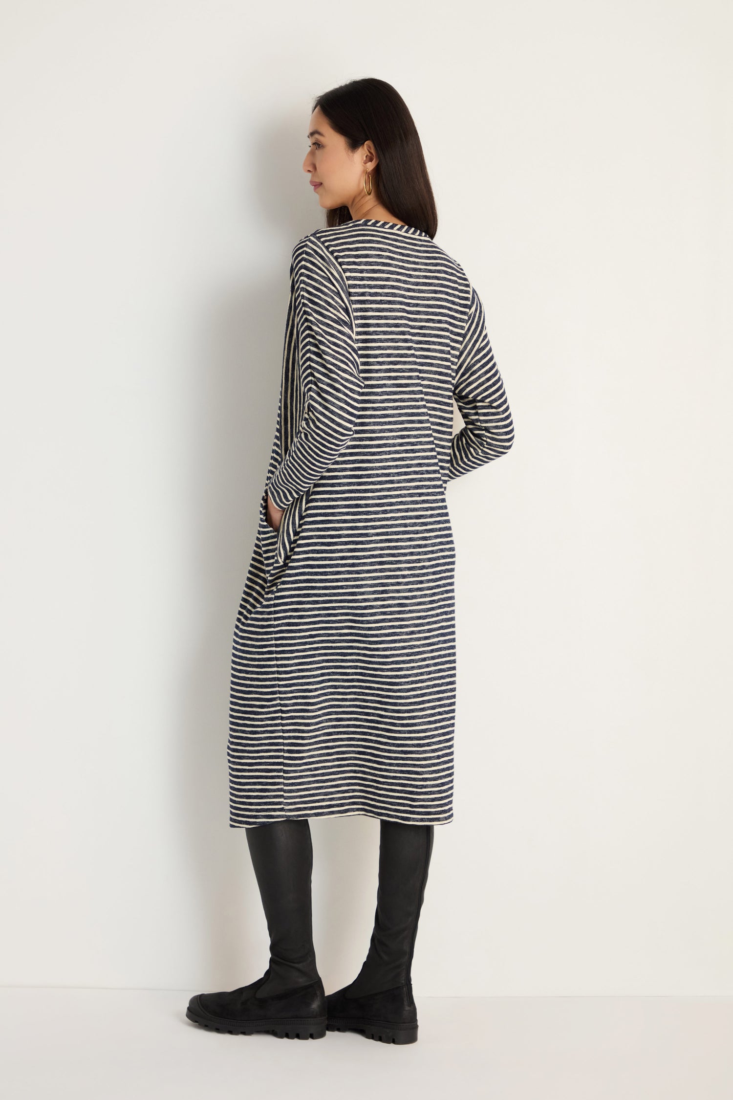 A woman wears the Textured Stripe Jersey Dress in a relaxed fit.