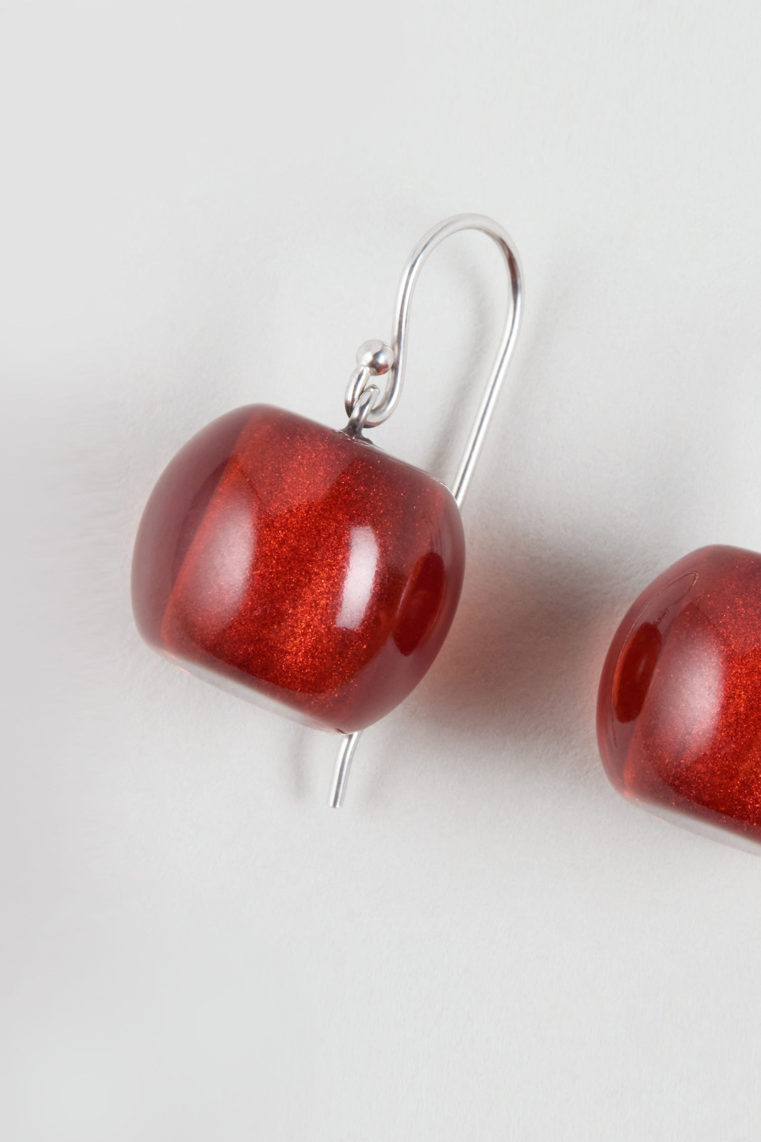 Close-up of a single Colourful Bead Resin Earring with a glossy red finish and silver hook on a plain white background—ideal for fans of modern jewellery.