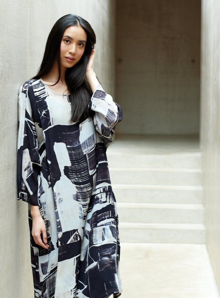 woman stood in black and white print dress