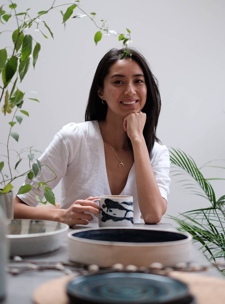 woman smiling sat at a table