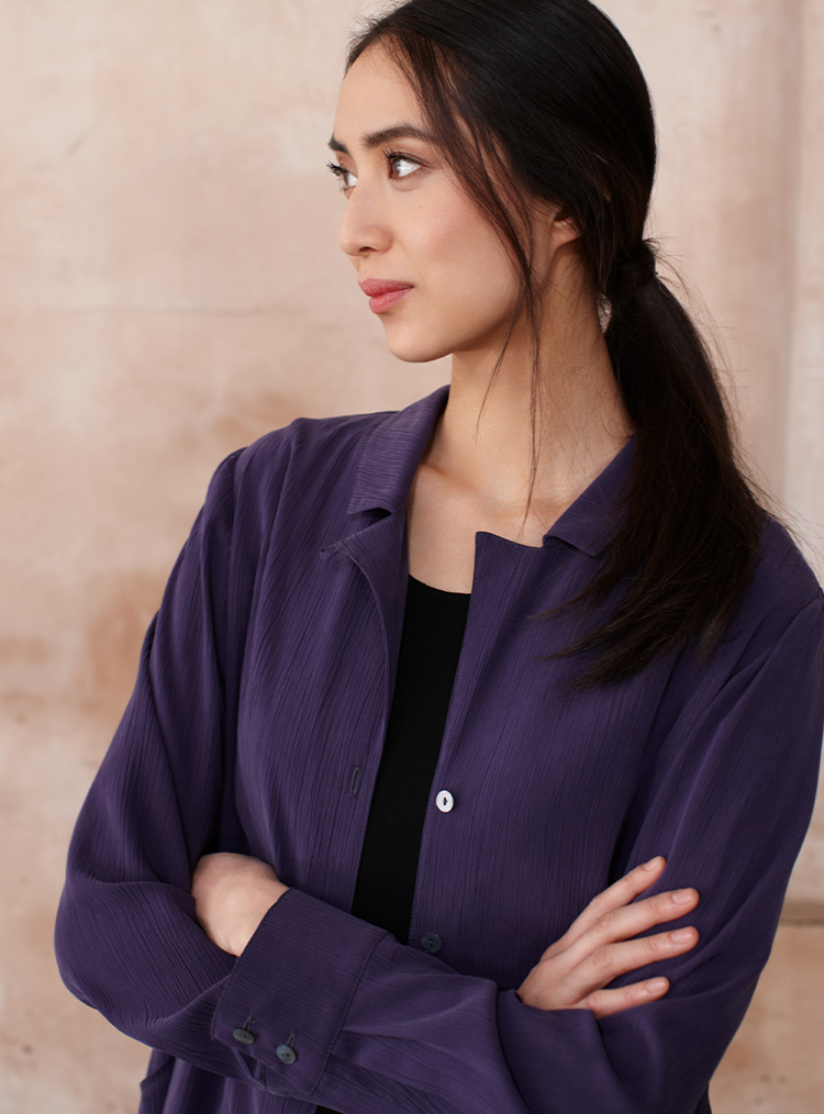 woman crossing her arms with a blue shirt