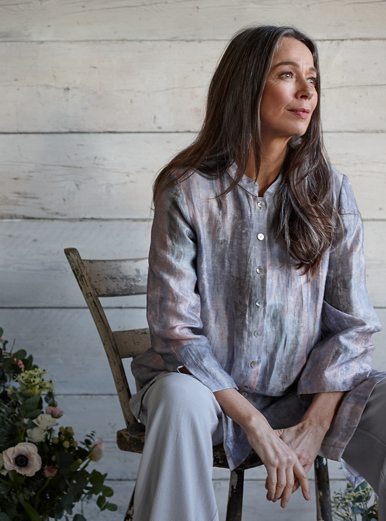 woman sat on a chair in a grey outfit