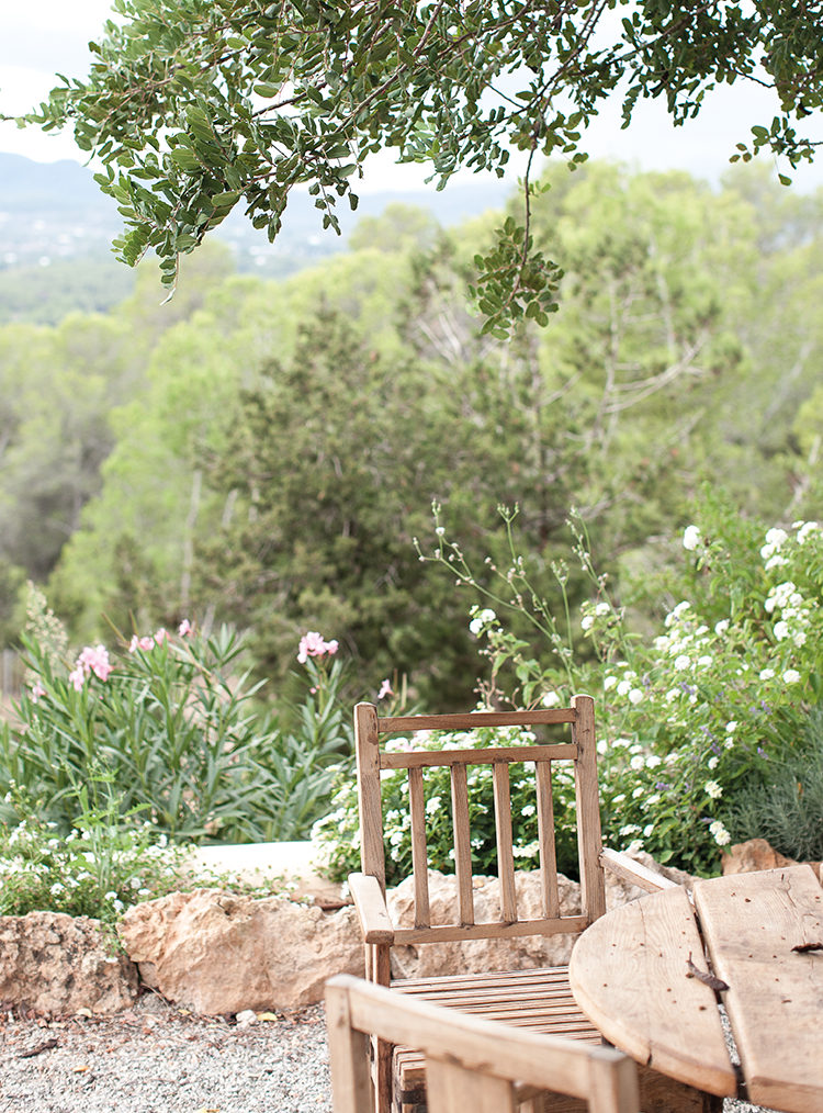 wooden chair and table in front of garden