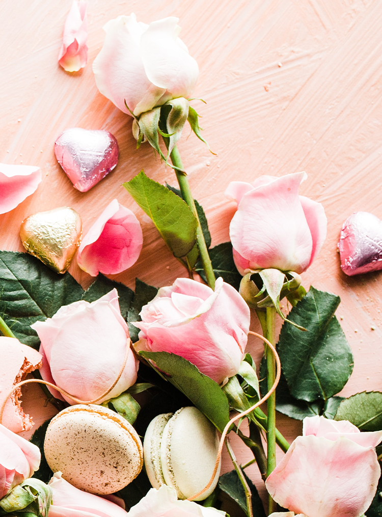 pink roses with macaroons and chocolates