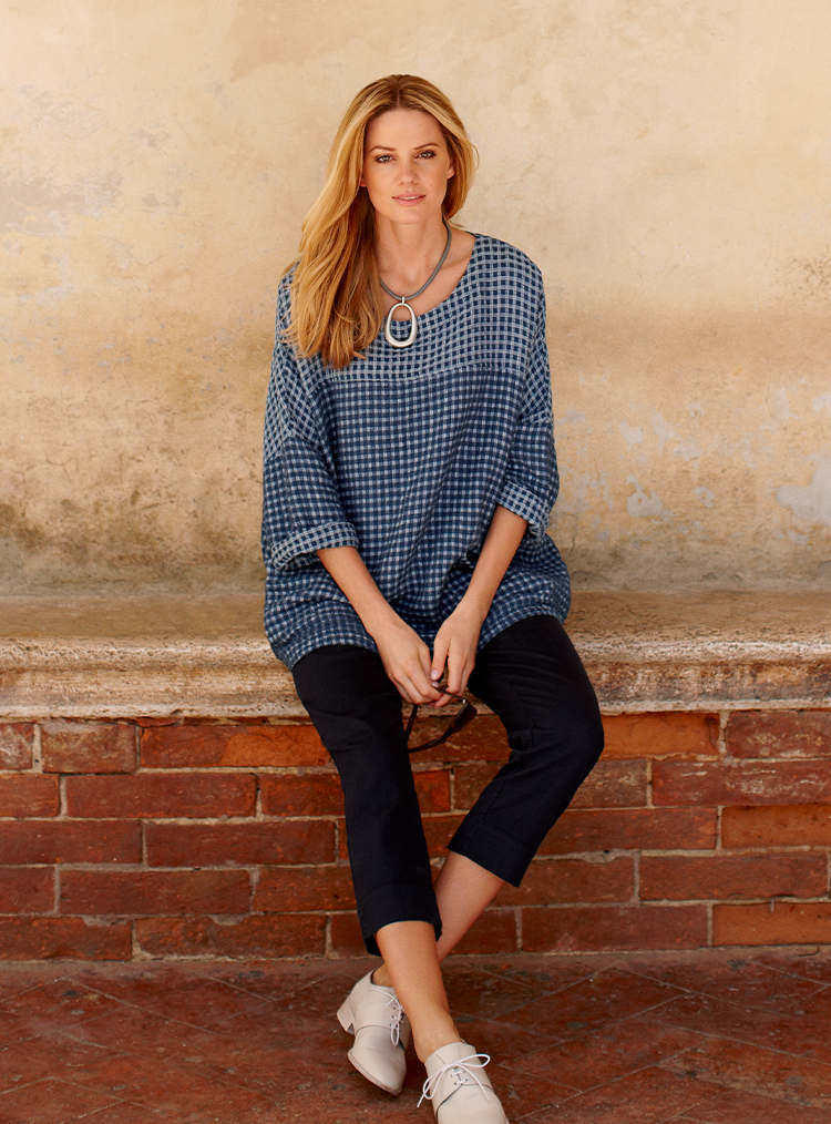 woman wearing a blue small checked top