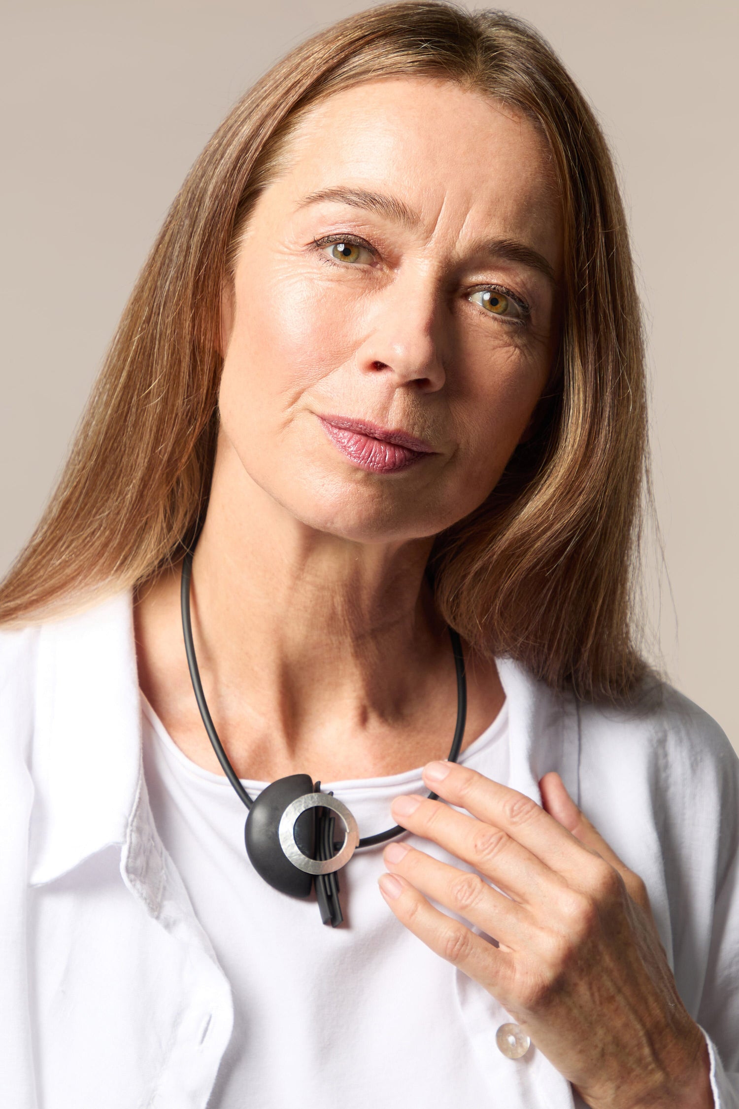 A woman wearing a stethoscope adorned with a Saturn Necklace.