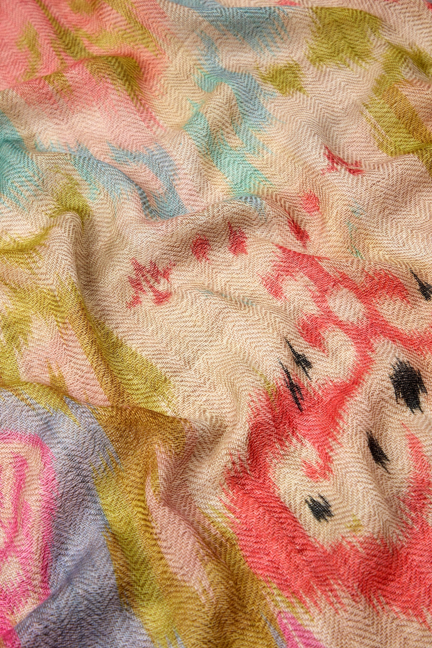 Close-up of a multicolored, herringbone-patterned fabric featuring a vibrant mix of pastel and bright colors like pink, green, blue, and beige. The Decorative Wool Cashmere Blend Scarf is ideal for versatile styling on any occasion.