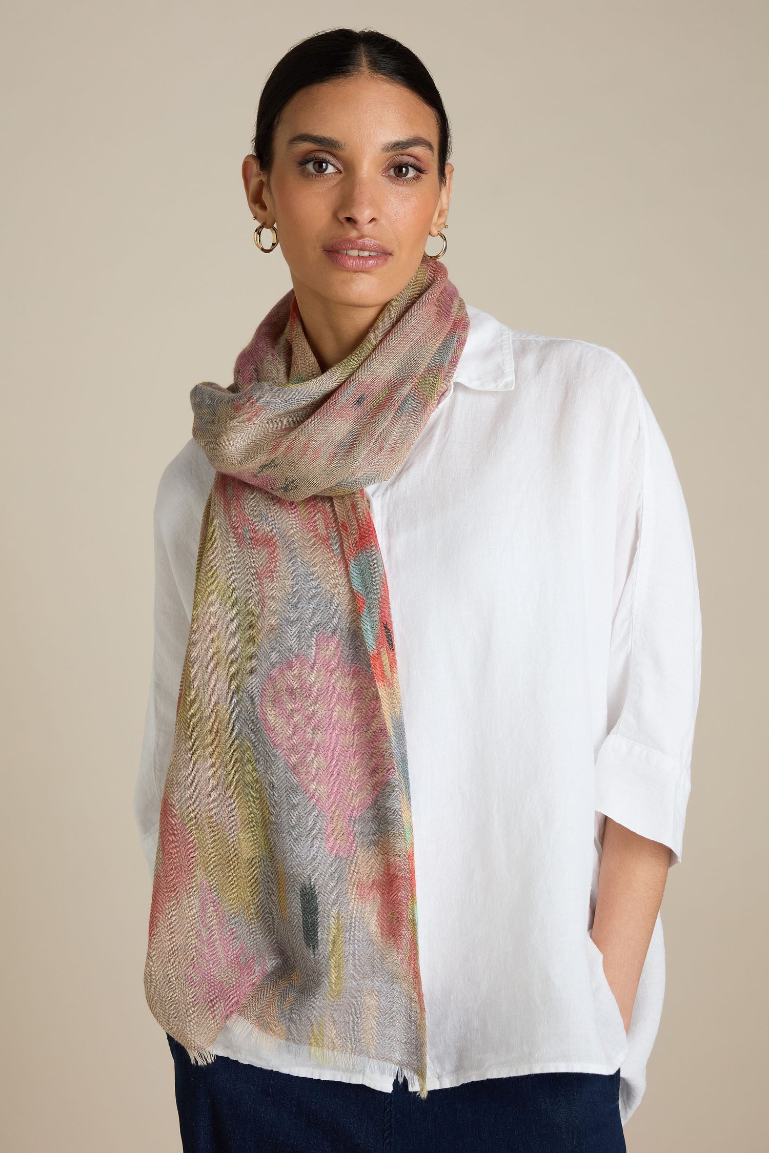 A person wearing a white shirt and a Decorative Wool Cashmere Blend Scarf, standing against a neutral background with hands in pockets, exemplifying versatile styling for any occasion.