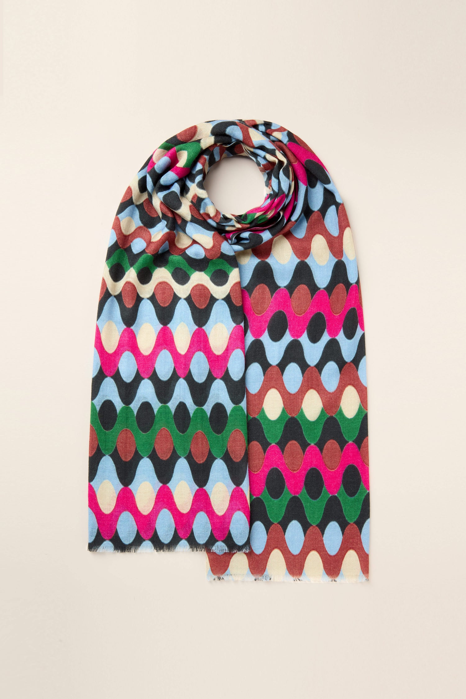 Introducing the Retro Waves Wool Mix Scarf, a vintage style accessory adorned with a retro pattern of oval shapes in vibrant colors such as red, green, blue, and beige, beautifully laid flat against a plain background.