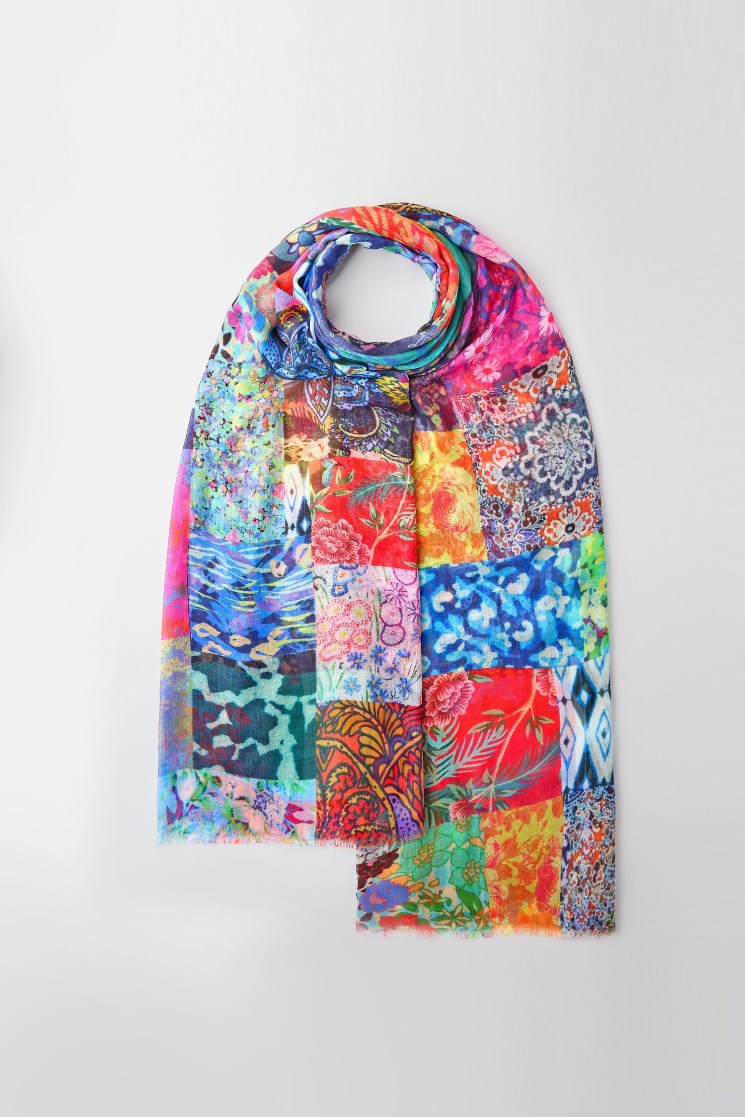 Introducing the Sahara Patchwork Scarf: a vibrant and lightweight accessory featuring intricate patterns on a white background, perfect for versatile styling at any occasion.