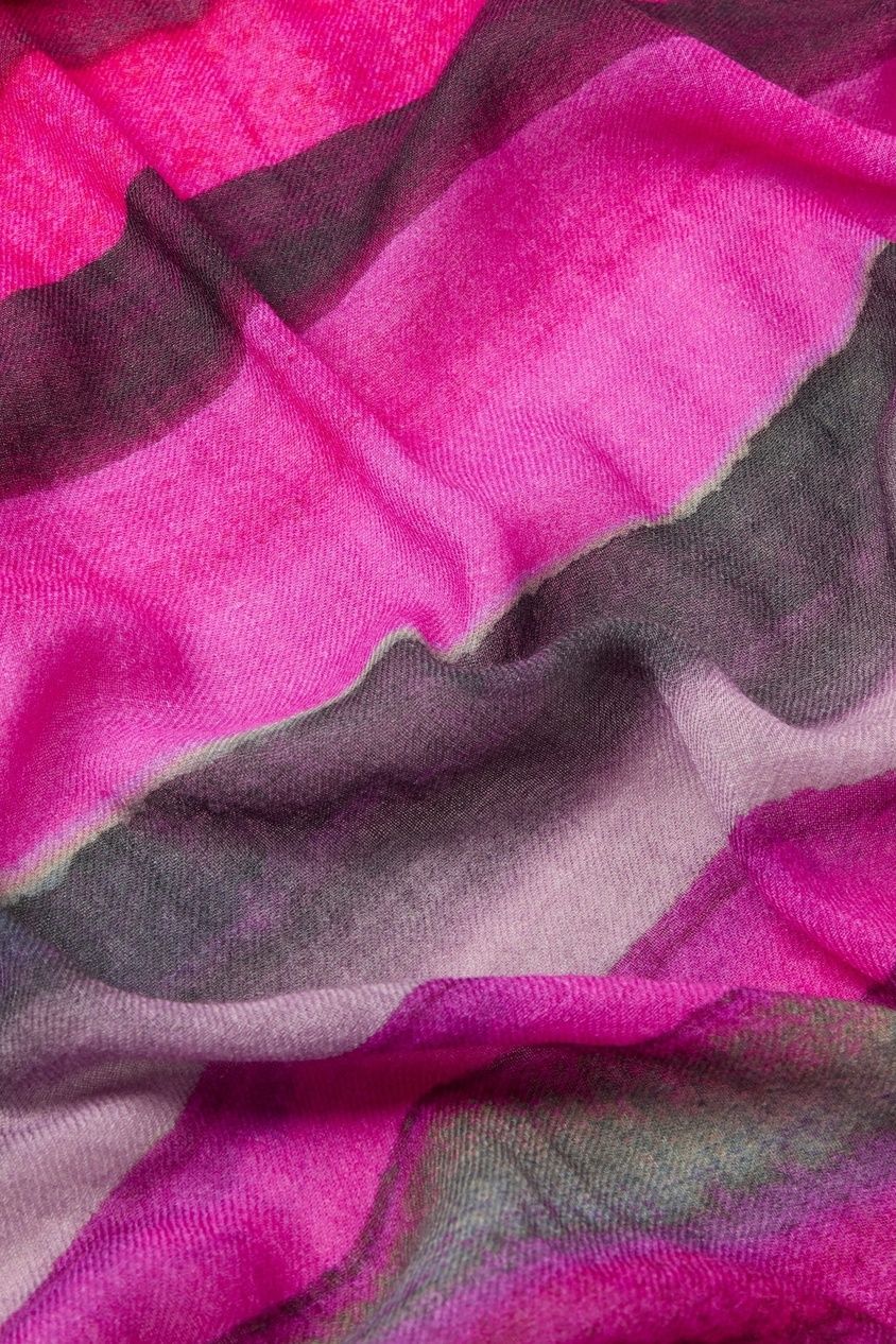 Close-up of a fabric with wavy sunset hues of pink, purple, and gray. Ideal for fall and winter or as part of the Crimson Twilight Stripe Scarf collection, capturing texture and folds.