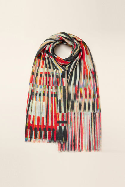 The Pianist Wool Mix Scarf showcases abstract patterns, including stripes and geometric shapes, reminiscent of a piano key print. Laid flat on a light background, this multi-colored luxurious accessory adds an artistic touch to any ensemble.