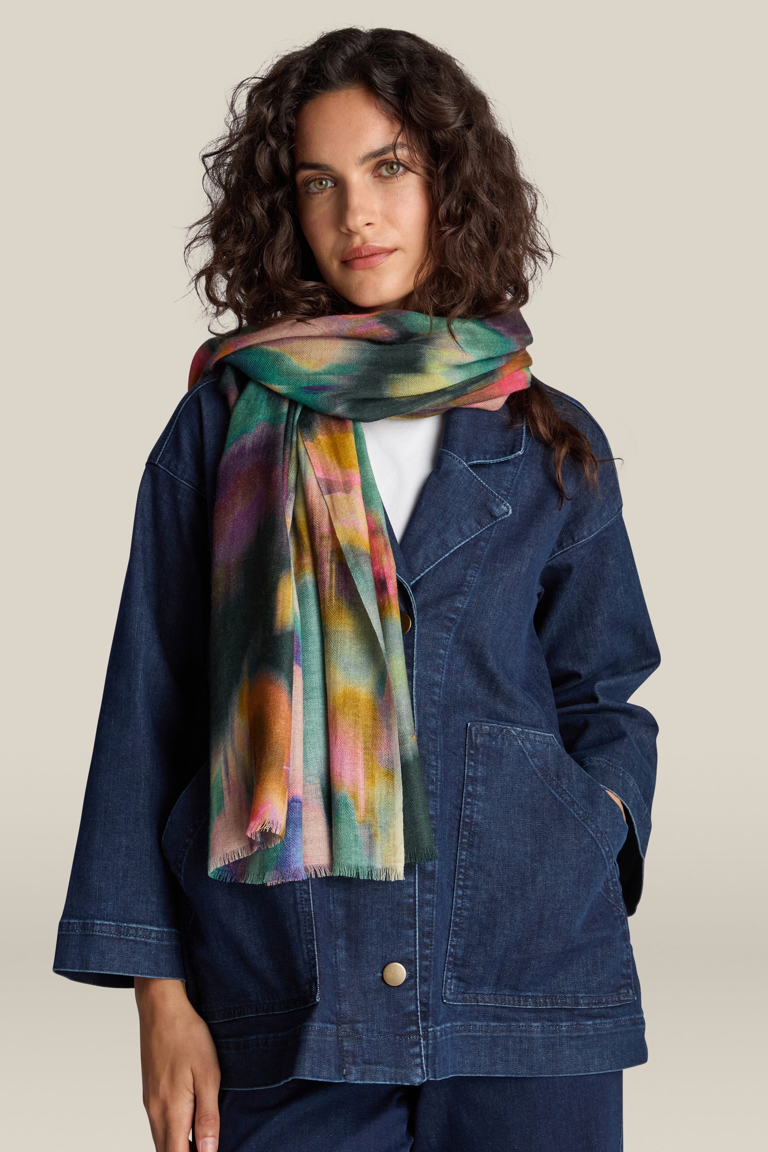 Person wearing a denim jacket and a jewel-tone Colour Fusion Wool Mix Scarf (Product Name: Colour Fusion Wool Mix Scarf) stands against a plain background.