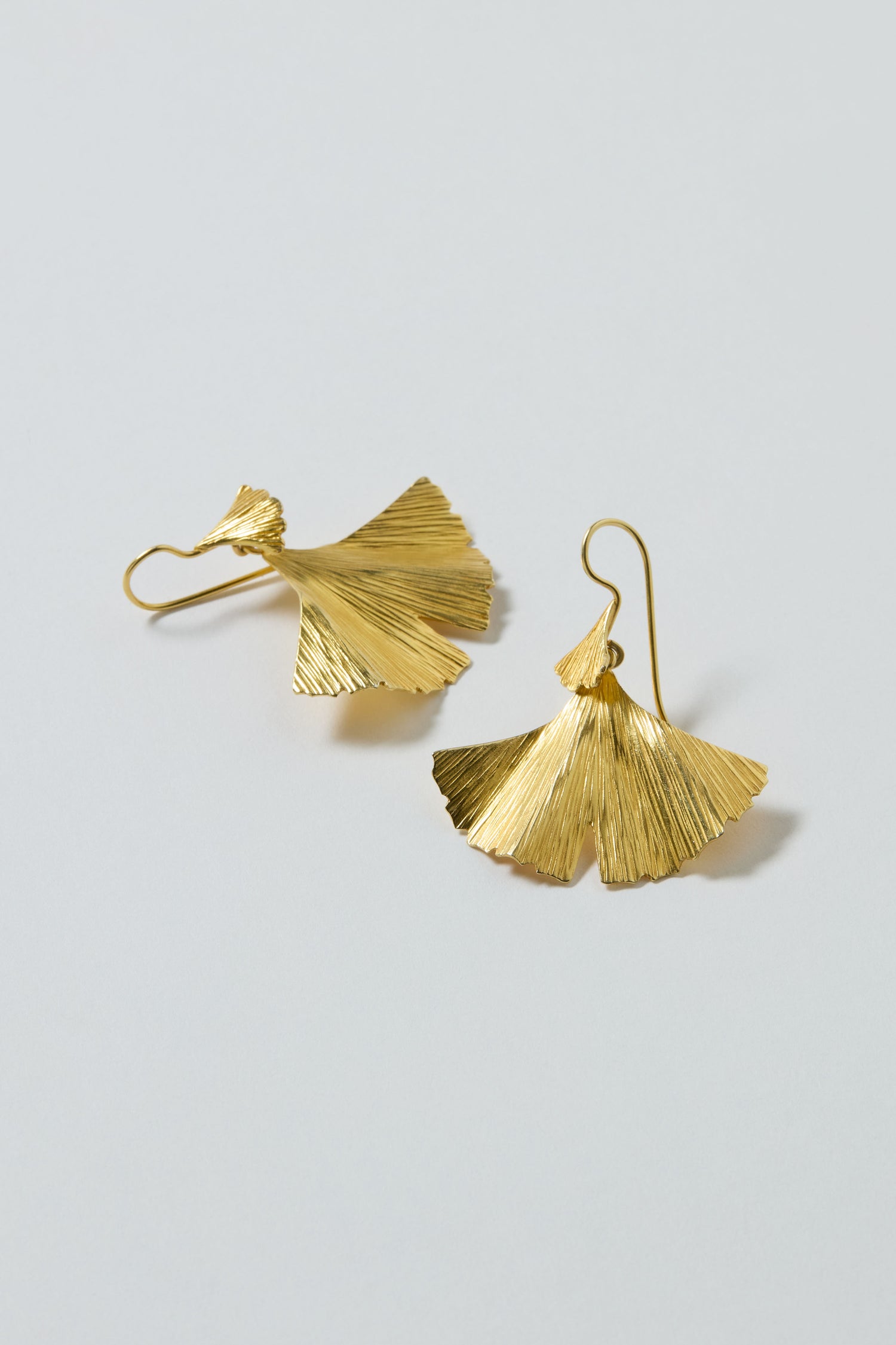 Gold Vermeil Ginkgo Leaf Earrings featuring textured, nature-inspired ginkgo leaf shapes, shown on a plain light background—ideal for lovers of botanical jewelry.