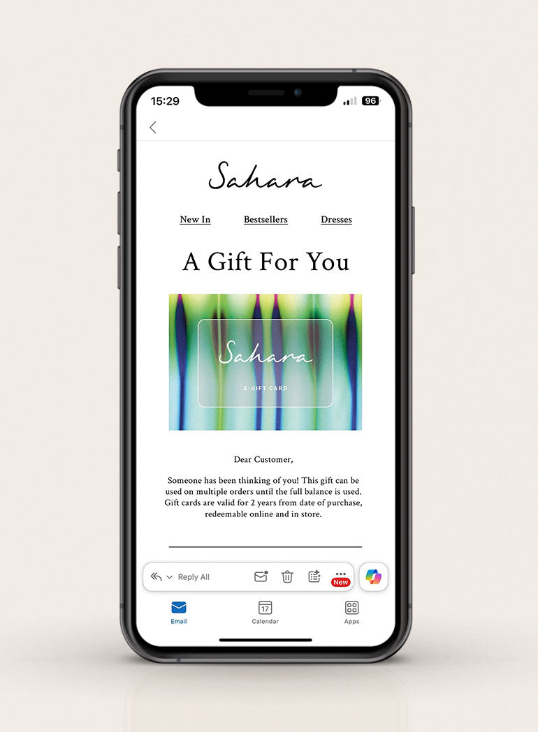 A smartphone displays an email with a vibrant Sahara E-Gift Card, featuring a colorful online gift card image and a heartfelt message for the recipient.
