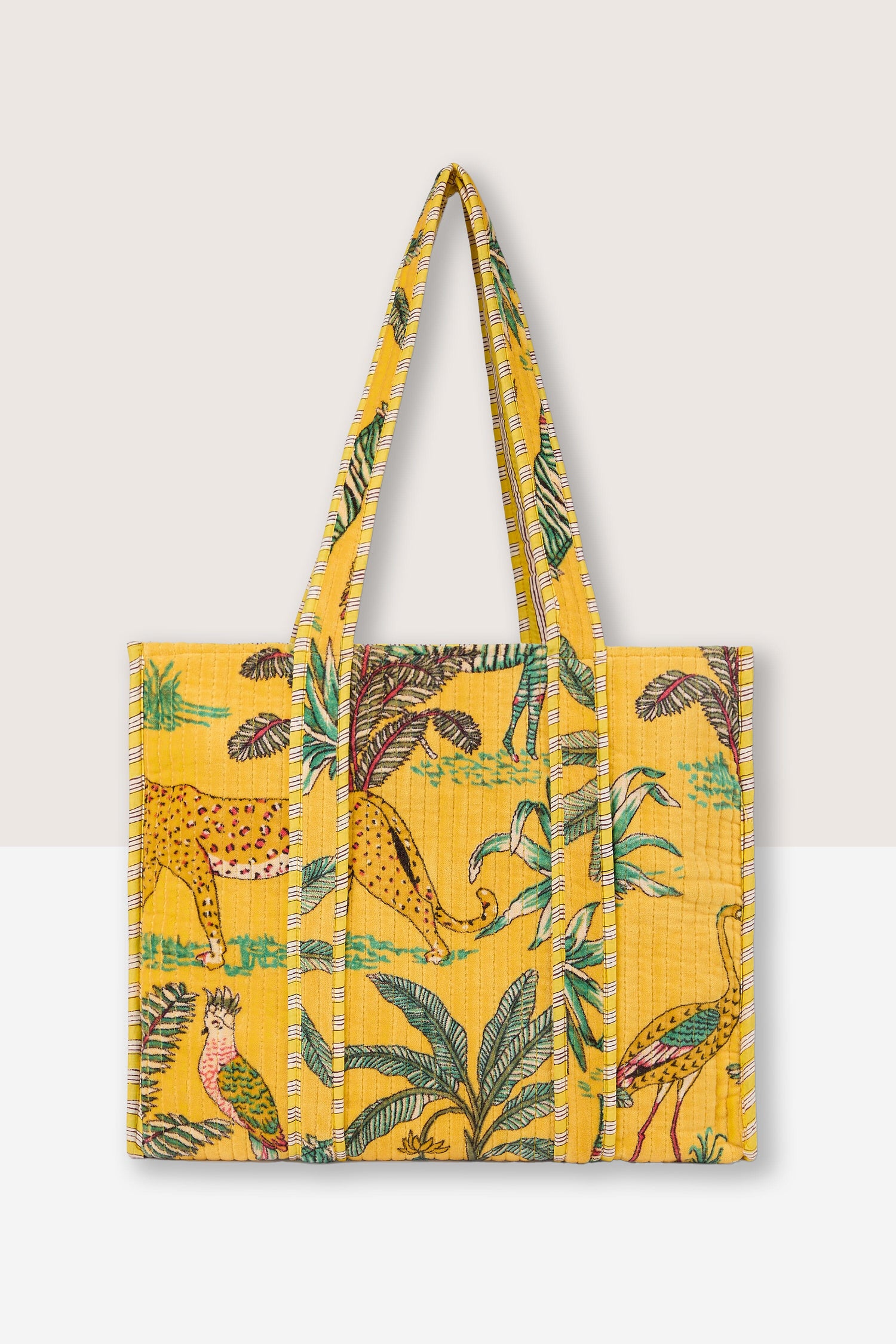 A stylish, Jungle Print Velvet Bag features colorful prints of a leopard, birds, and tropical foliage.