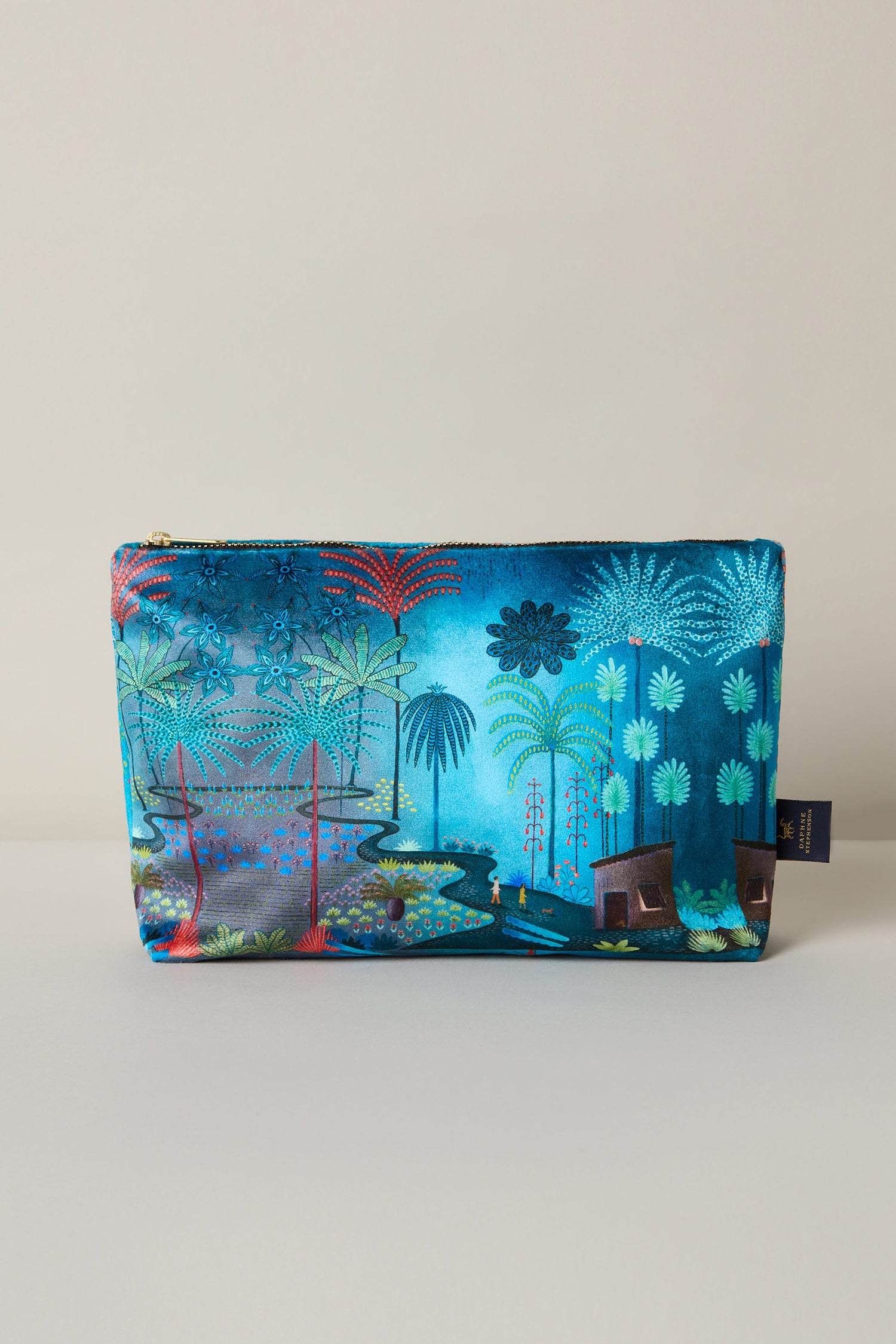 The Large Jungle Pathway Velvet Bag features a vibrant tropical scene with palm trees and lush foliage on a blue and green background, beautifully designed by Daphne Stephenson in luxurious velvet.