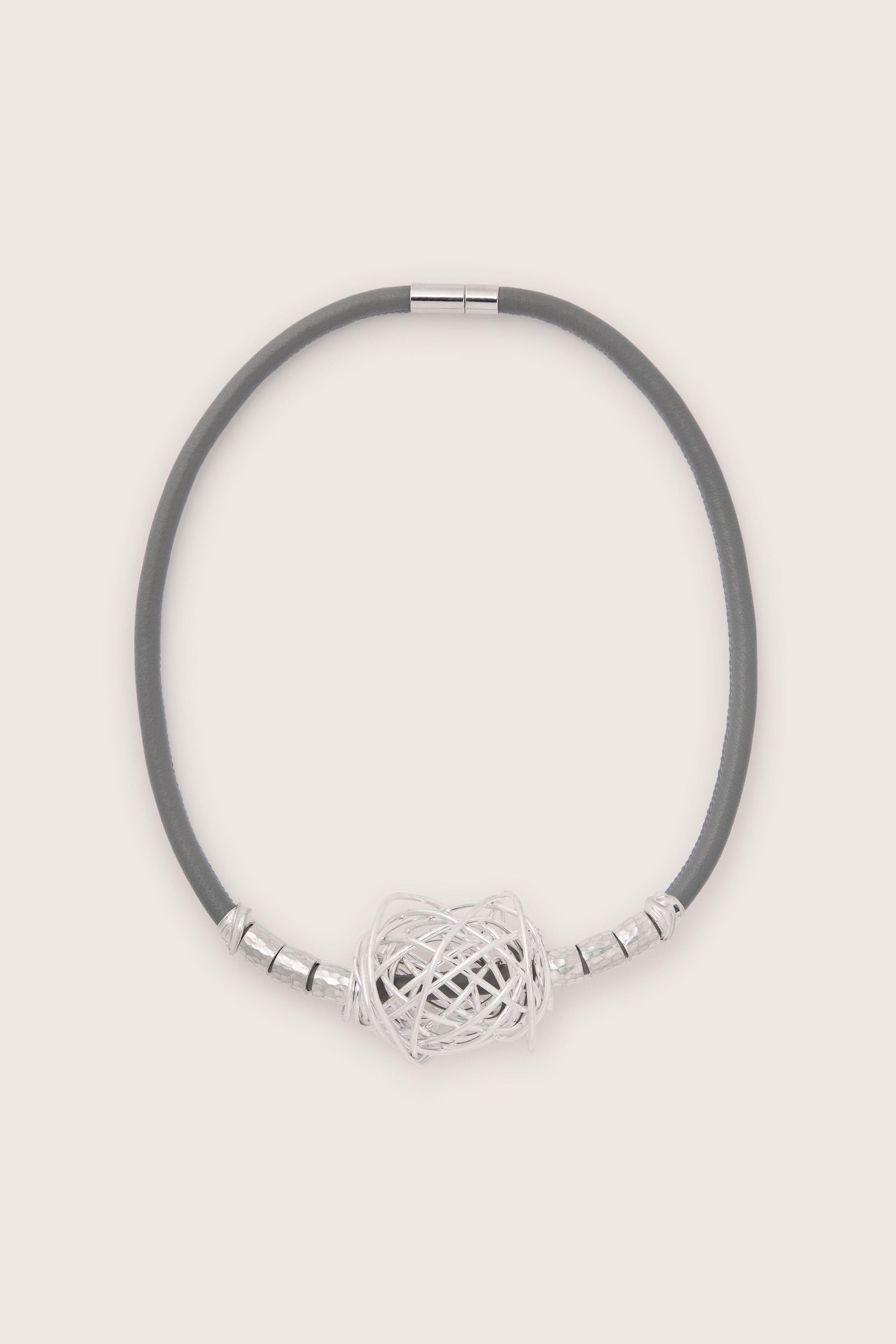 A gray leather cord necklace with a silver decorative knot at the center, adorned by silver cylindrical accents on both sides, beautifully showcases Scribble Bead Leather Cord Necklace craftsmanship.