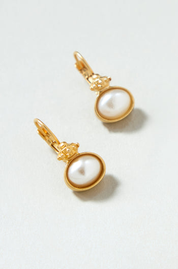 Gold Plated Pearl Drop Earrings featuring oval-shaped white pearls, shown elegantly on a light surface.