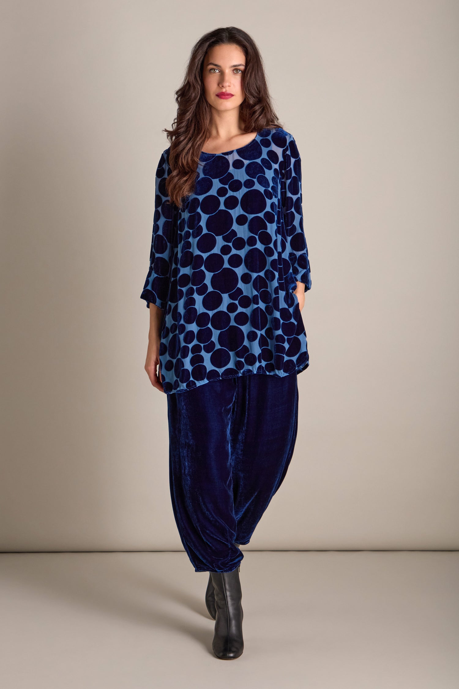 A person wearing the Spot Devore Top and dark velvet pants stands against a plain background.