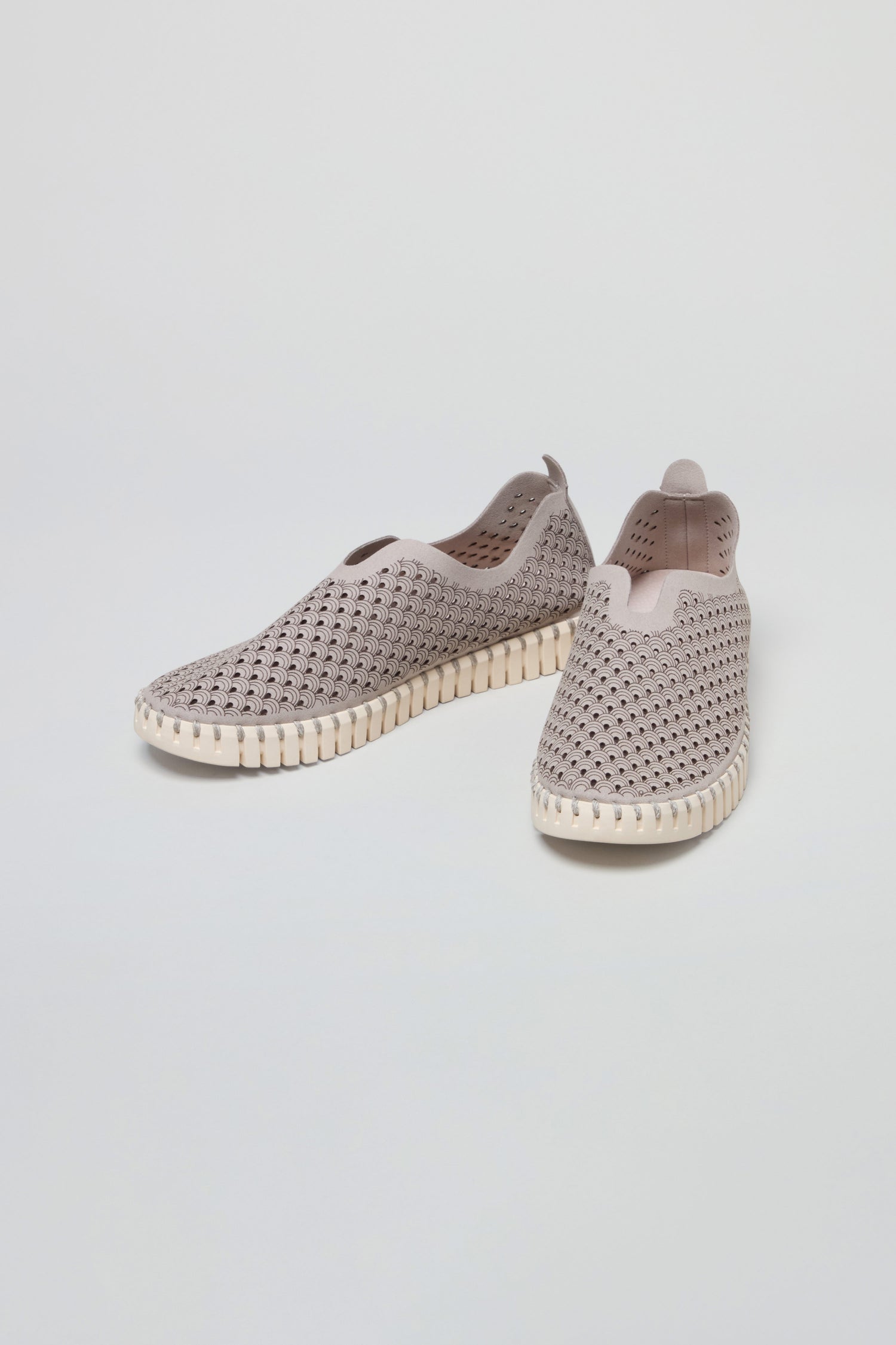 Grey Tulip Slip On Shoes featuring perforated uppers and white textured soles, inspired by Scandinavian design, are displayed on a plain white background.