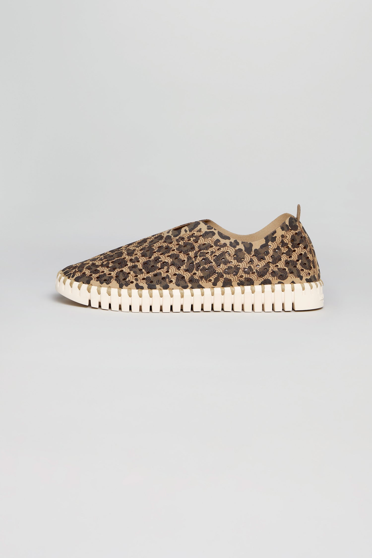 The Tulip Leopard Slip On Shoes from Ilse Jacobsen feature a textured beige sole and are shown in profile on a light gray background—ideal for those seeking stylish, sustainable casual footwear.