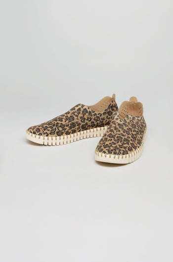The Tulip Leopard Slip On Shoes feature brown and black leopard print uppers with a tan sole, displayed on a plain white background—ideal for anyone seeking stylish, sustainable casual footwear.