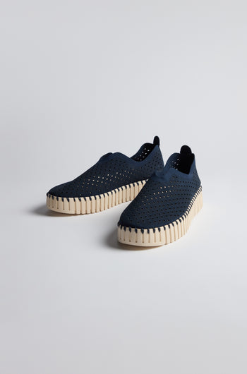 A pair of Indigo Tulip Platform Slip On Shoes featuring perforated recycled microfiber uppers and thick off-white textured soles, displayed on a plain light background.