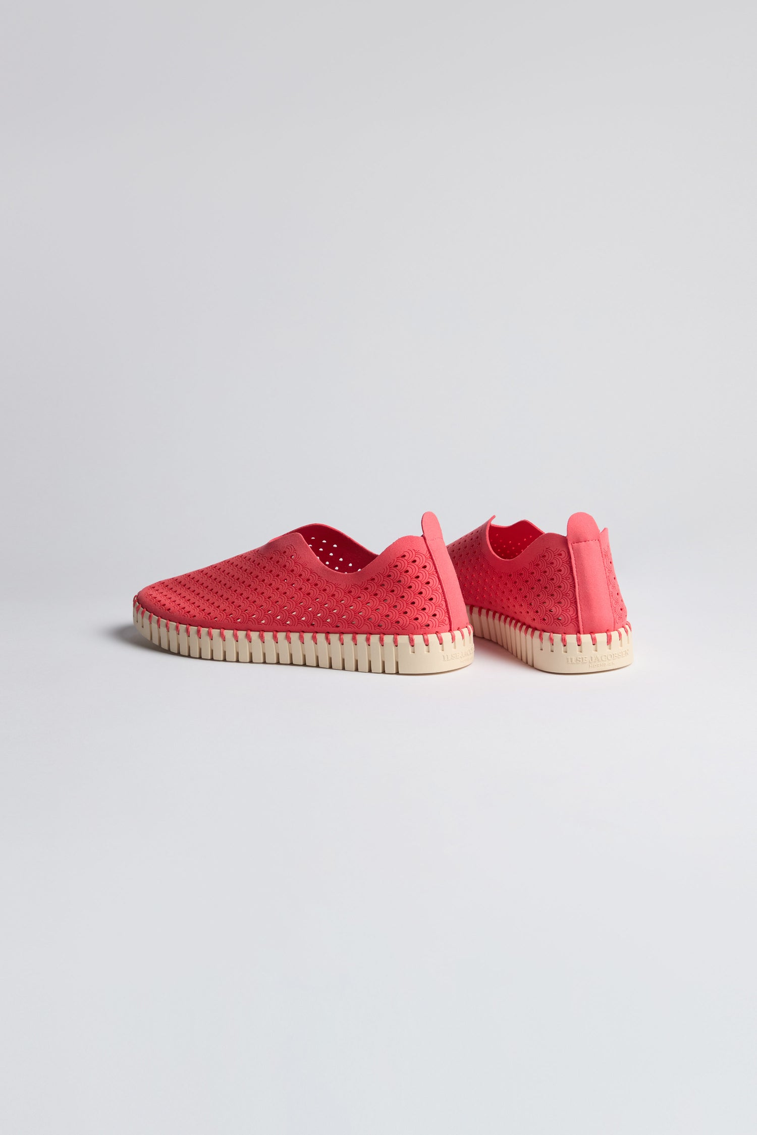 A pair of Raspberry Tulip Platform Slip On Shoes with perforated recycled microfiber uppers and white soles is displayed on a plain light background. One shoe faces forward, the other is angled back.