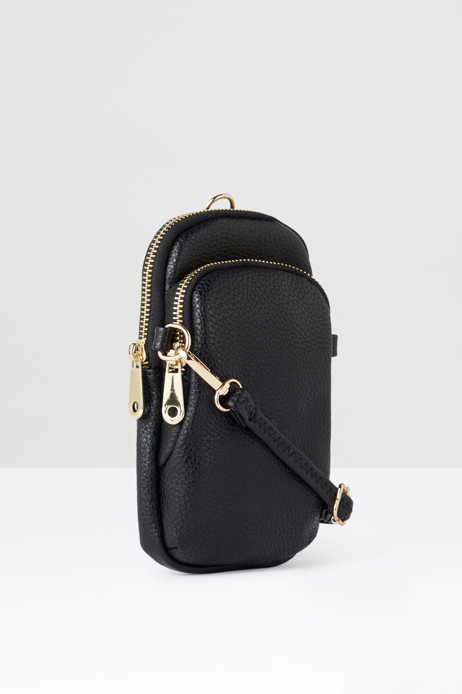 A style-led Mini Crossbody Bag with black cross body styling and gold hardware.