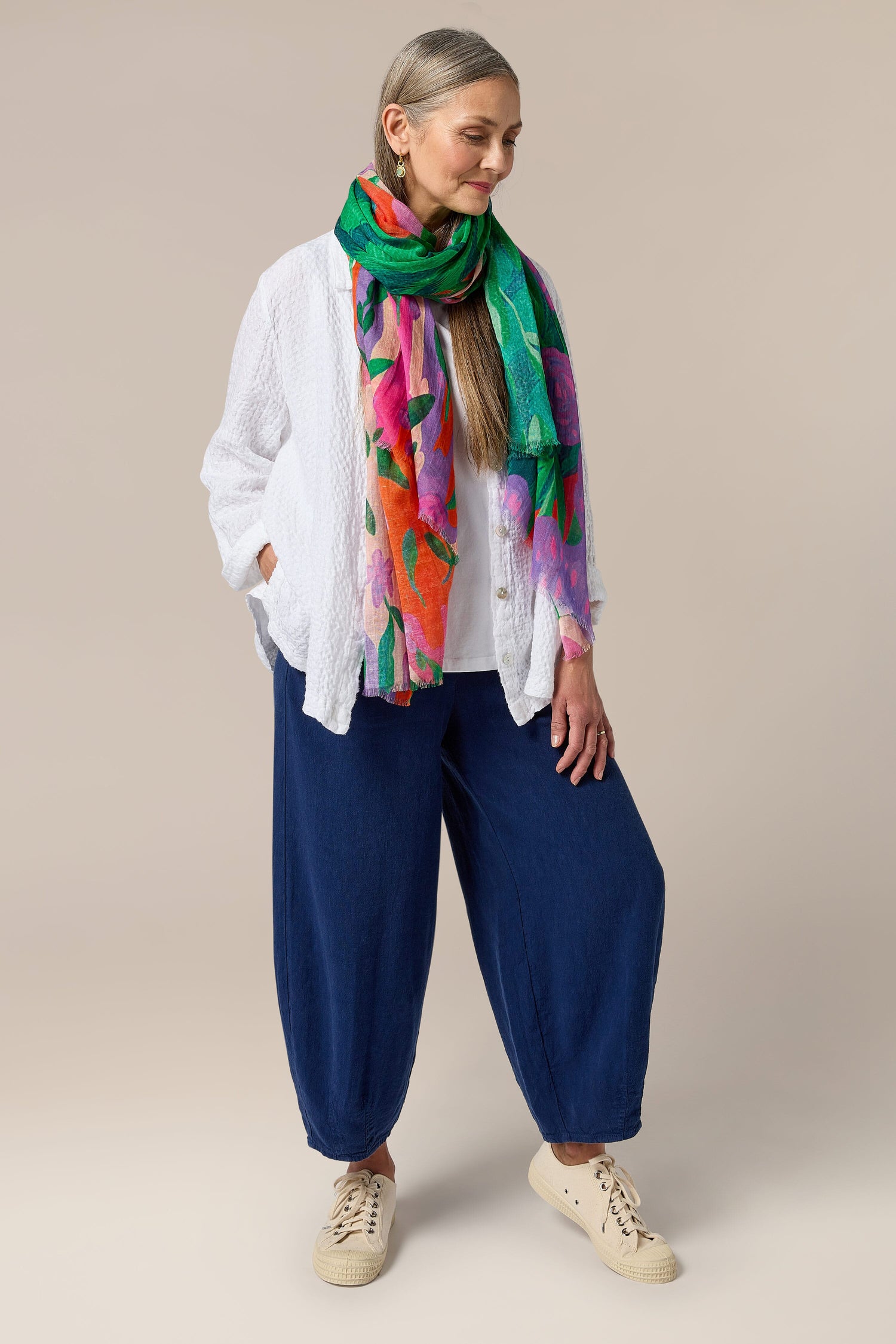 A woman wearing a colorful Twisted Linen Bubble Trouser made of linen fabric.