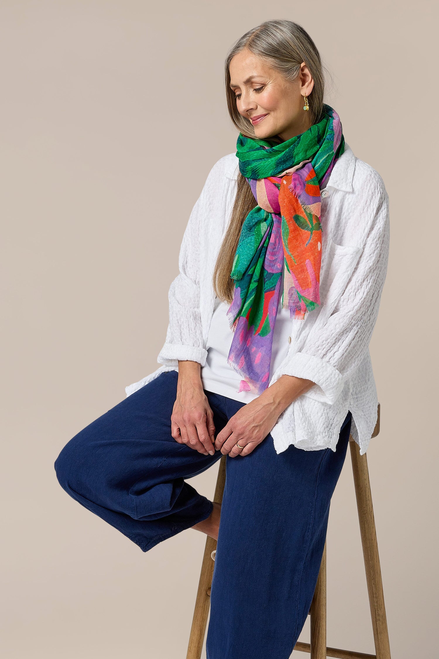 A woman sitting on a stool wearing Twisted Linen Bubble Trouser made of linen fabric.