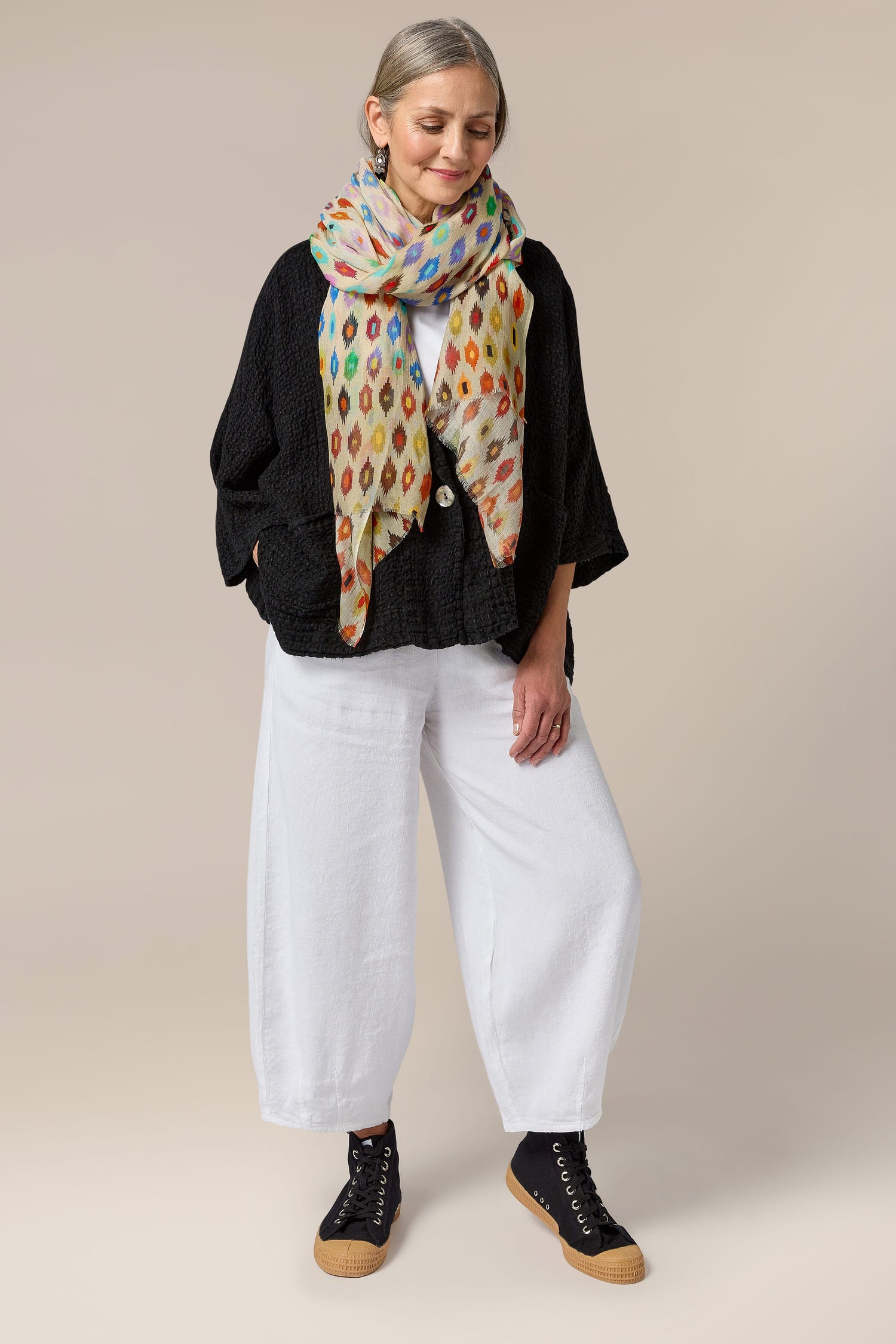 A woman wearing Twisted Linen Bubble Trouser with an elasticated waistband and a black scarf.