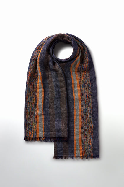 The Denim Detail Linen Stripe Scarf, with vibrant vertical stripes in orange, blue, and brown, is displayed neatly folded on a plain white background. It's an ideal accessory to brighten up your spring and summer wardrobe.