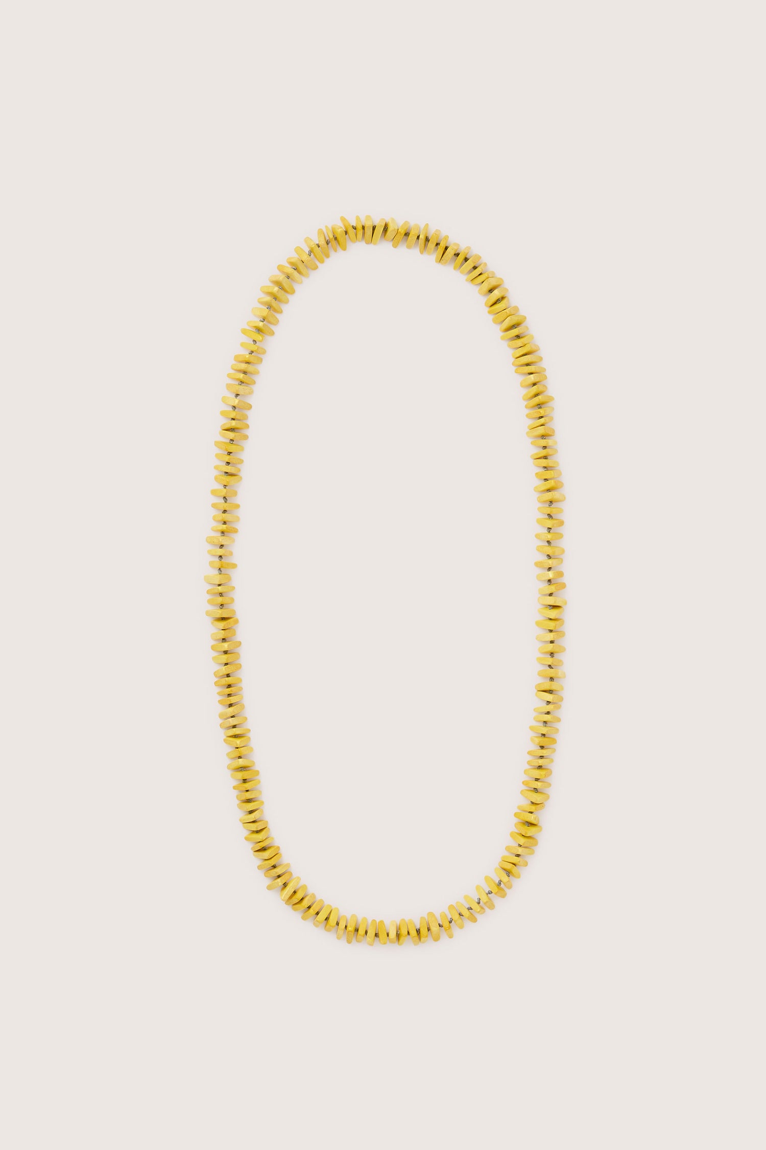 The Mini Triangles Wooden Necklace features yellow beads in a continuous loop, displayed against a plain background. This piece of handmade wooden jewelry combines elegance with simplicity, making it a timeless addition to any collection.