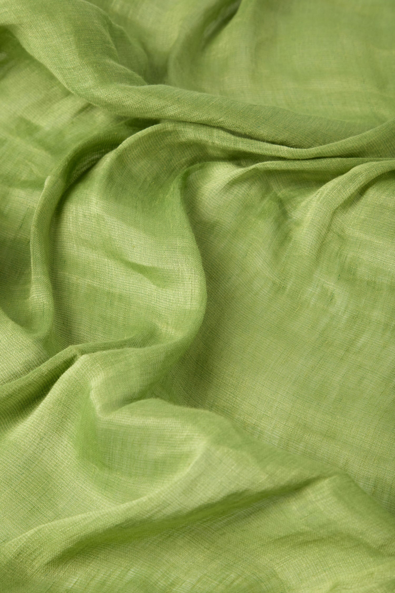 Close-up of a luxurious linen fabric with gentle folds and creases, showcasing the texture of a Soft Linen Scarf.