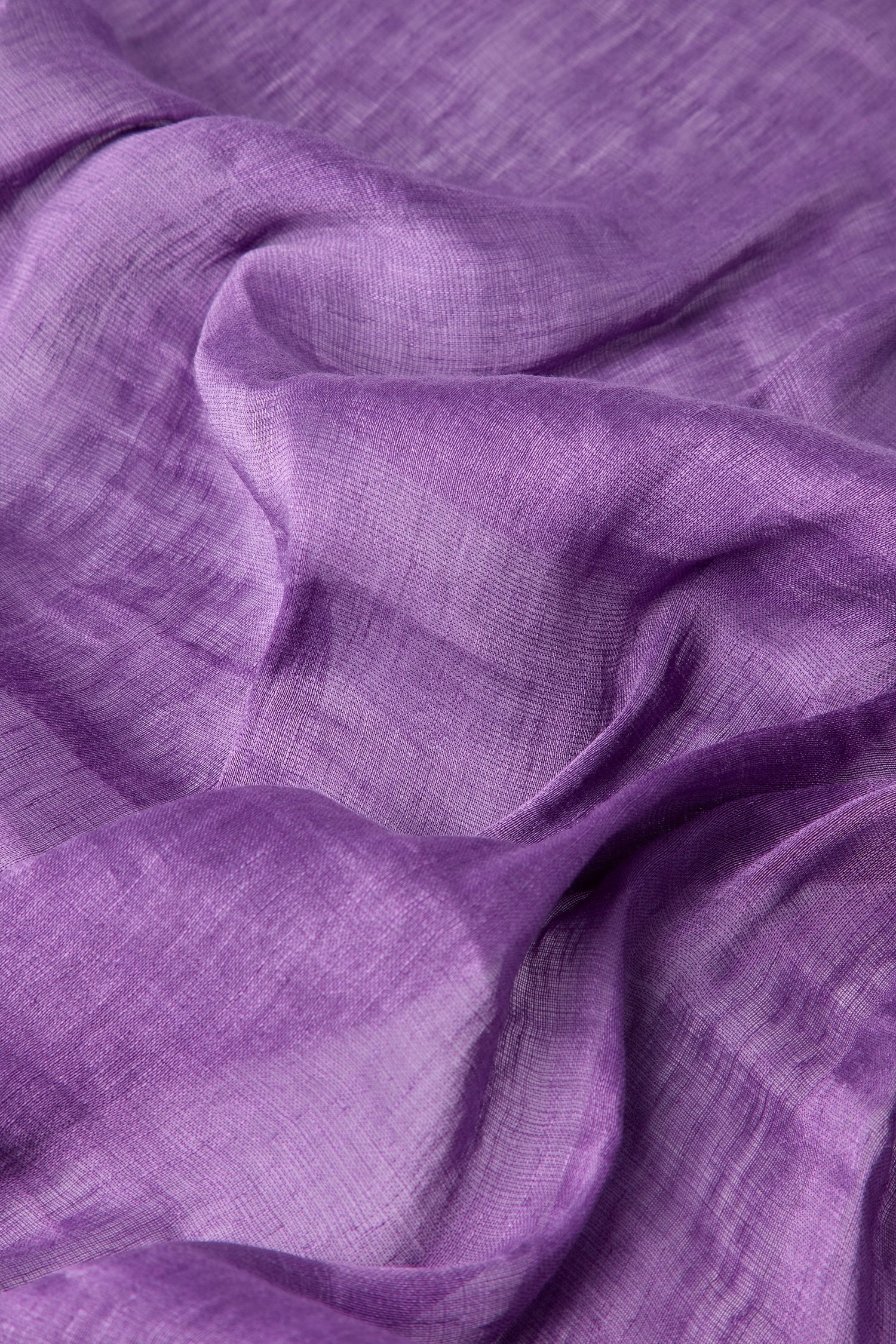 Close-up of the Soft Linen Scarf in a rich purple hue, highlighting its soft texture and elegant folds, meticulously crafted through responsible fair trade practices.