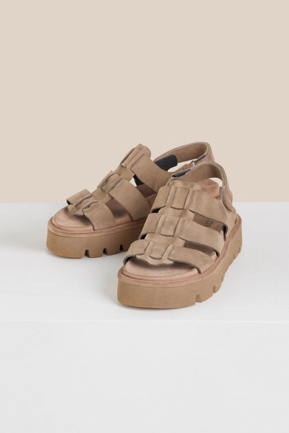 Brown Italian-crafted Suede Platform Velcro Sandals with multiple straps gracefully rest on a white surface against a beige background, presented in a Sahara colourway for style and comfort.