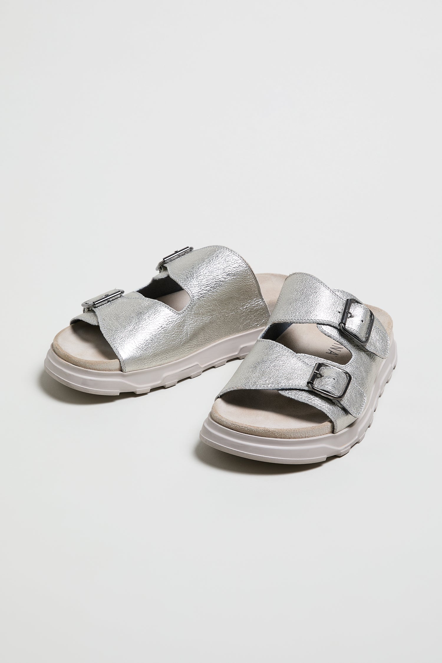 Double Buckle Leather Sliders in metallic silver feature two adjustable buckle straps and white rubber soles, style LOFI1E240, shown on a plain white background.