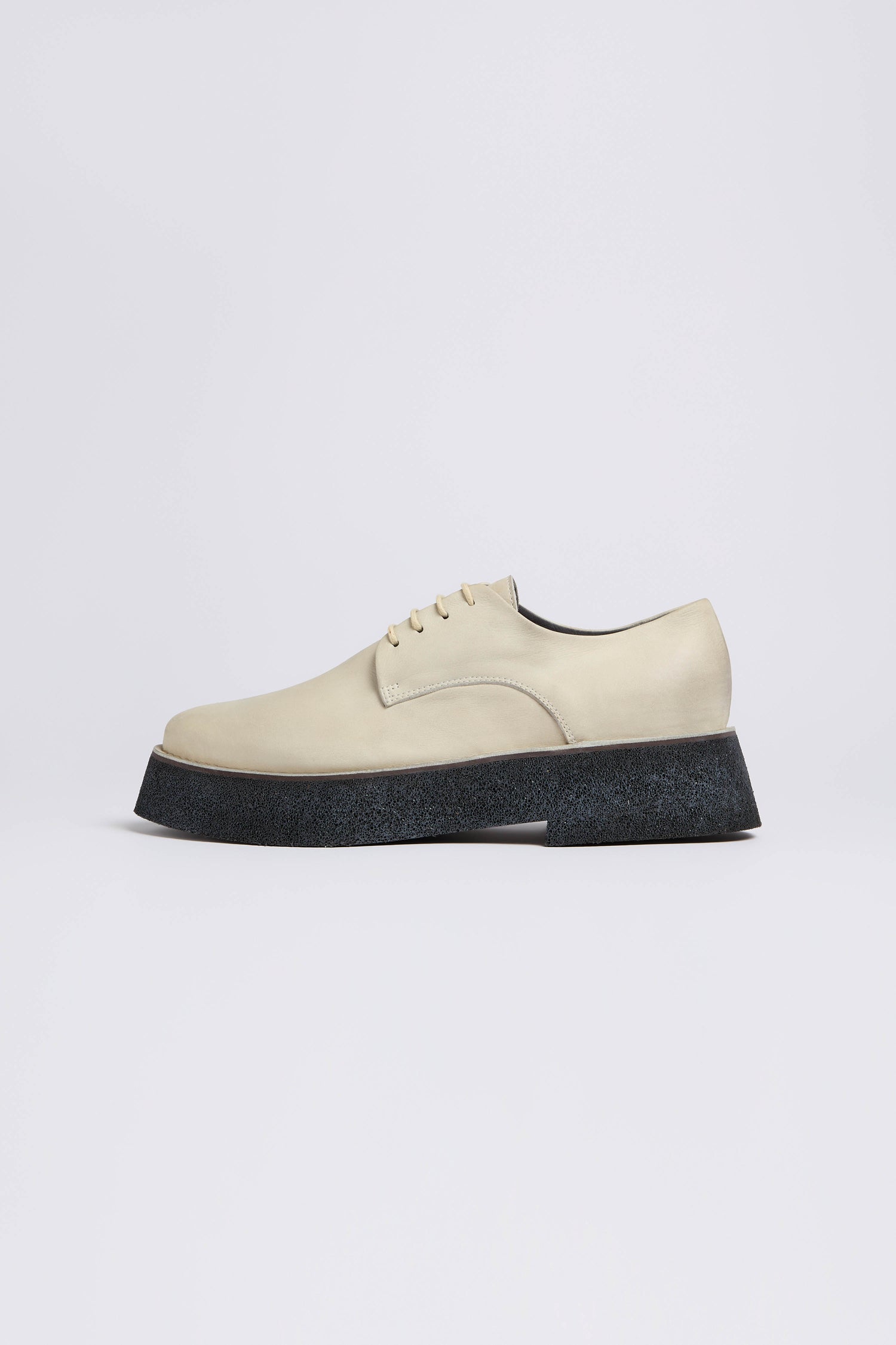 The Lace up Leather Brogues feature a beige finish and a modern platform sole, handcrafted in Italy. Set against a plain white background, these shoes seamlessly blend elegance with contemporary style.