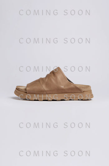 The Crushed Leather Sliders are shown against a light background with “COMING SOON” repeatedly overlaid in gray.