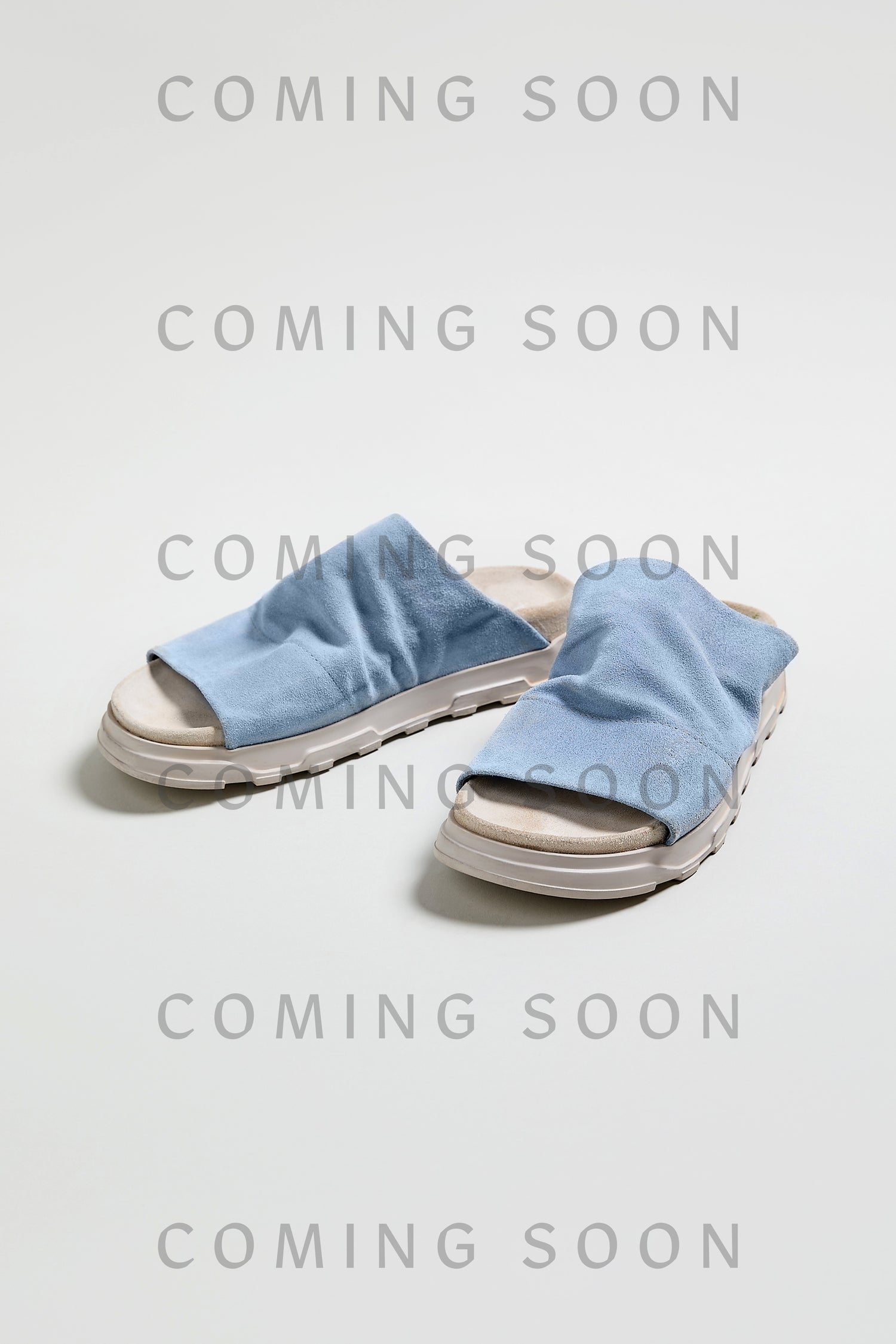 Crushed Suede Sliders in light blue, style LOFI3364, are shown on a white background with "COMING SOON" overlaid—get ready to step into SS26’s must-have look!.