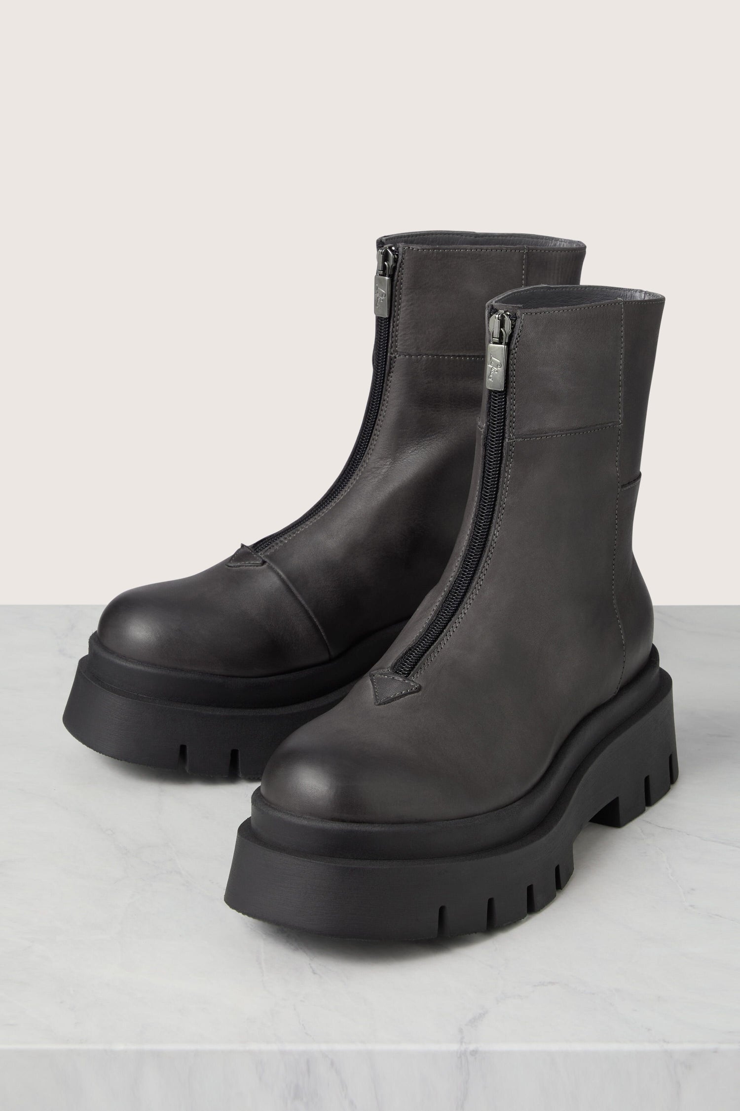 Danish design meets Italian craftsmanship in this pair of stylish grey leather ankle boots. With their convenient zippers, these Platform Zip Front Leather Boots are a must-have accessory.